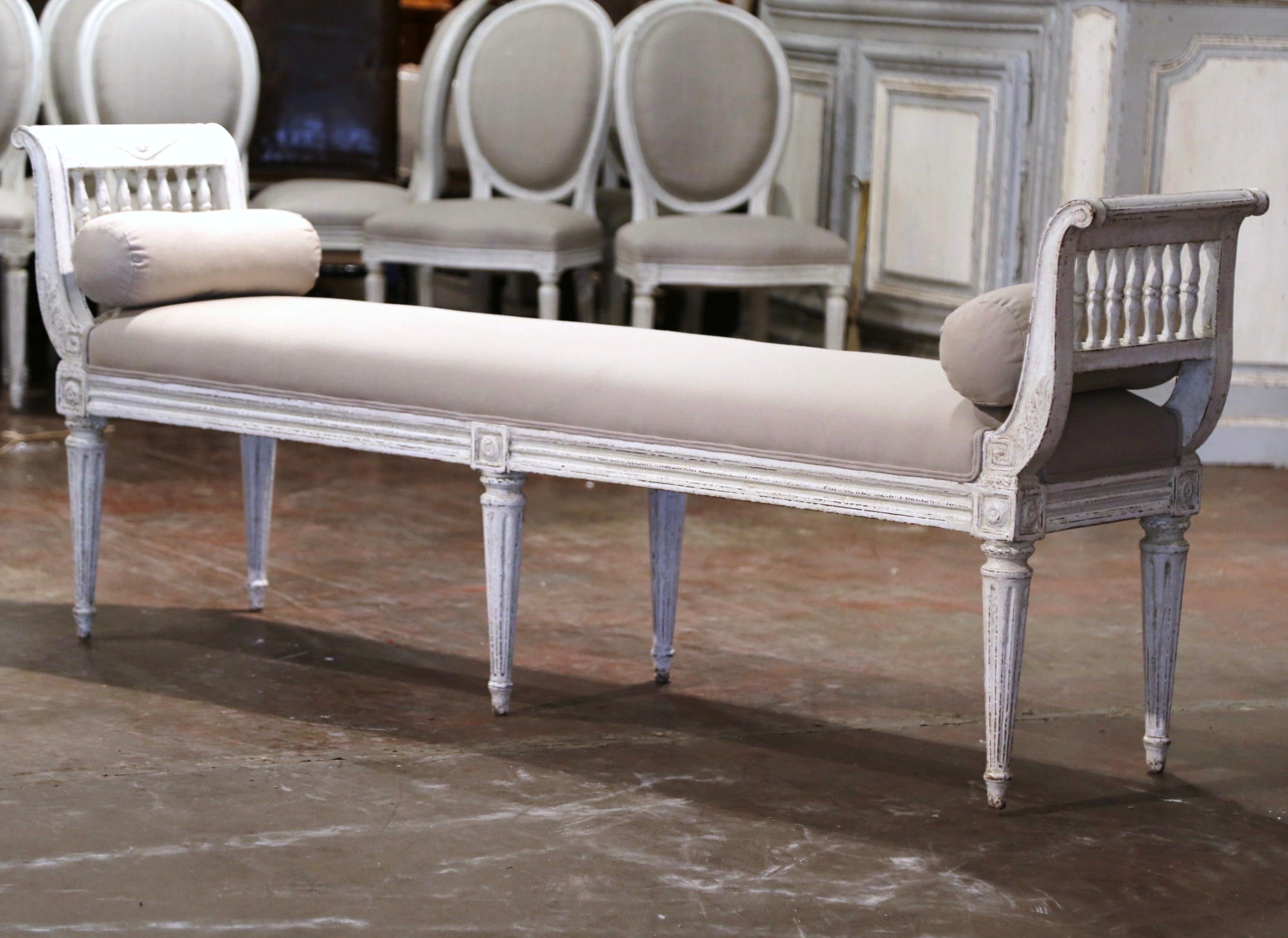 Place this elegant antique bench at the foot of a king size bed or in your living room for extra, versatile seating. Crafted in France, circa 1880, the traditional banquette stands on six tapered and fluted legs embellished with carved acanthus