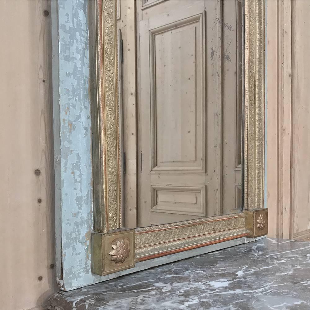 19th century, French Louis XVI carved panel painted Trumeau with gold highlights features a lovely Swedish soft blue painted surround that has achieved a quaint distressed patina, which combined with the other elements including the distressed