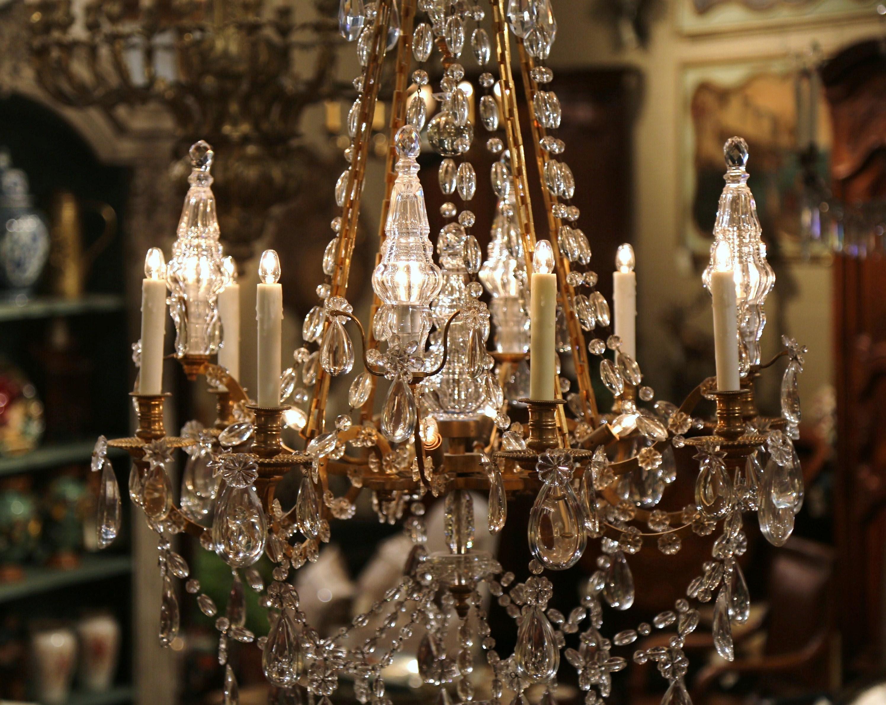 Make a grand statement in your entry or dining room with this impressive Louis XVI antique chandelier. Crafted in France, circa 1870, the elegant, baroque light fixture has eight lights embellished with wax candle sleeves, on a single tier over a