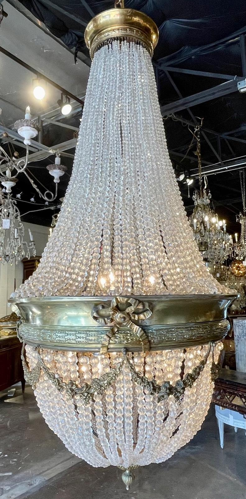 19th century French Louis XVI style gilt bronze and beaded crystal basket chandelier. Circa 1890. The chandelier has been professionally re-wired, cleaned and is ready to hang. Includes matching chain and canopy.
