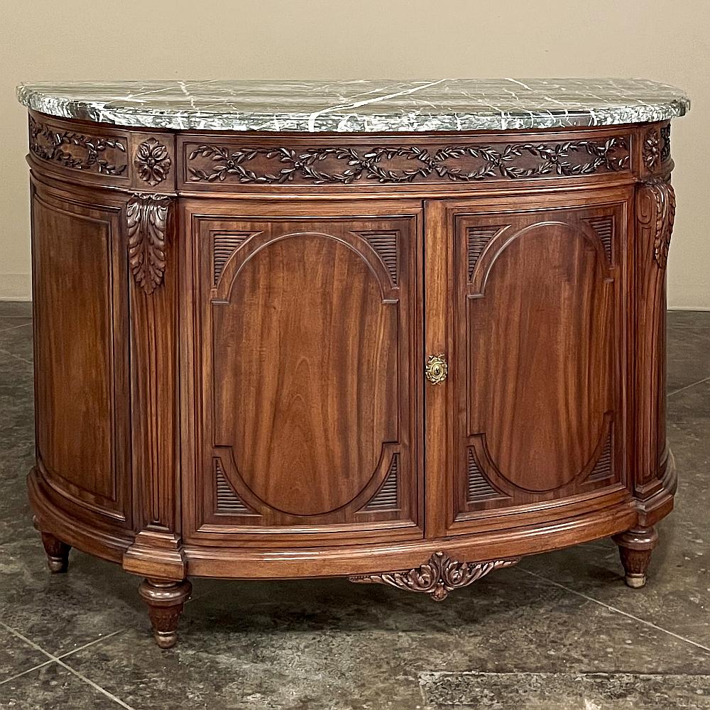 19th Century French Louis XVI Demilune Mahogany Marble Top Buffet is a remarkable work of the cabinetmaker's art! Requiring an expert design as well as craftsmanship, it features a fully curved casework in a demilune form that presents no corners or