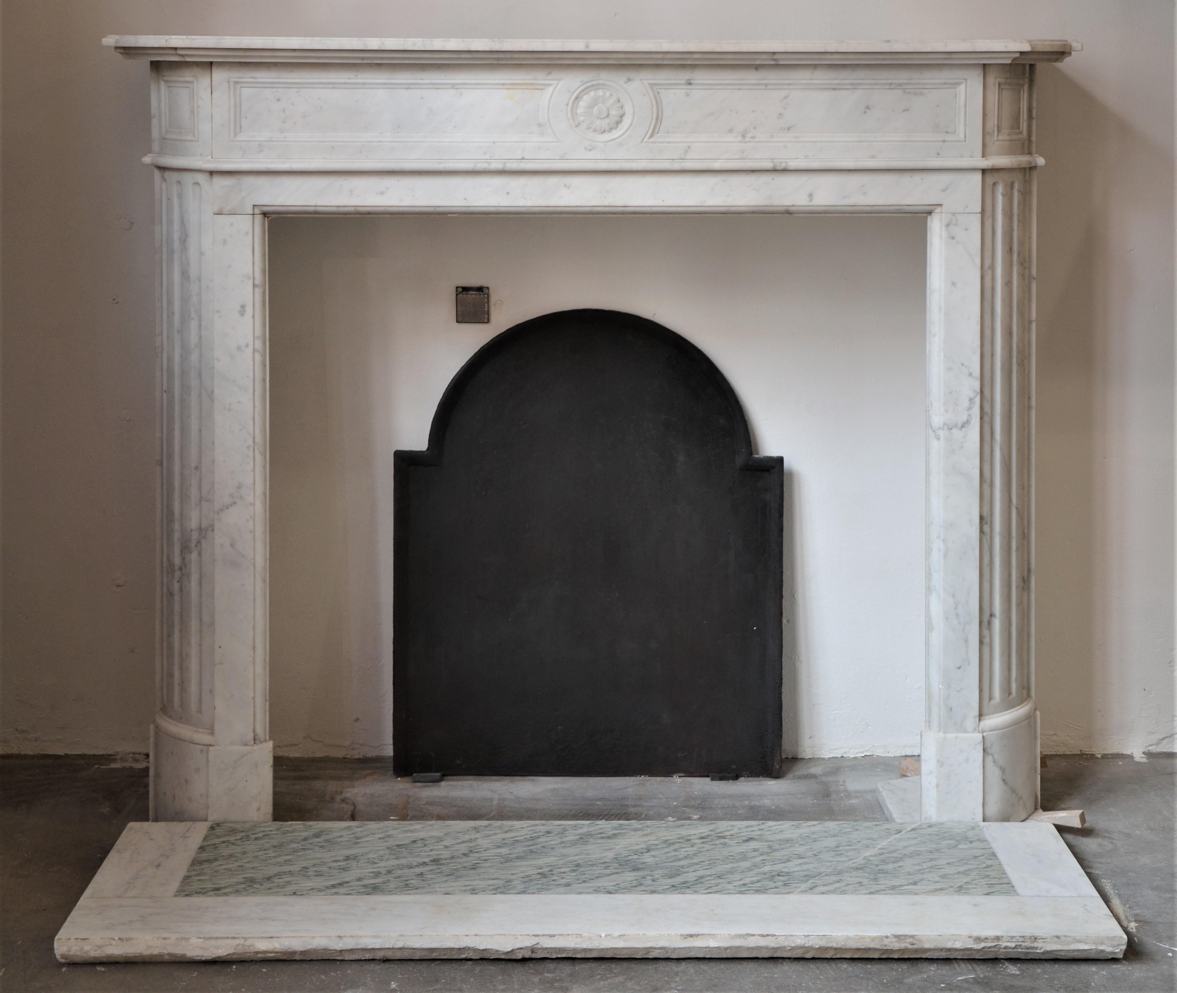 This 19th century Louis XVI style fireplace with half-moon shape top shelf and round fluted jambs is very decorative.
Marble floor included.

Opening measurements: 38.2 x 40.2 inch (height x width).