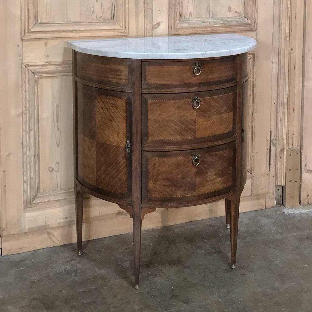 19th century French Louis XVI demilune marble-top commode was finished with fine imported mahogany, with cast bronze key guards and drawer pulls and leg tips to add the perfect accents. The finishing touch is provided by beveled, contoured marble on