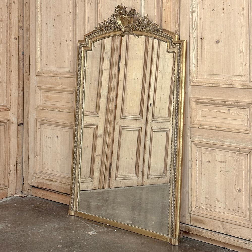 19th Century French Louis XVI Gilded Mantel Mirror is a testament to the master craftsmen of France, who have been leaders in the production of mirrors for centuries!  This example features a stately neoclassical design all around, with a