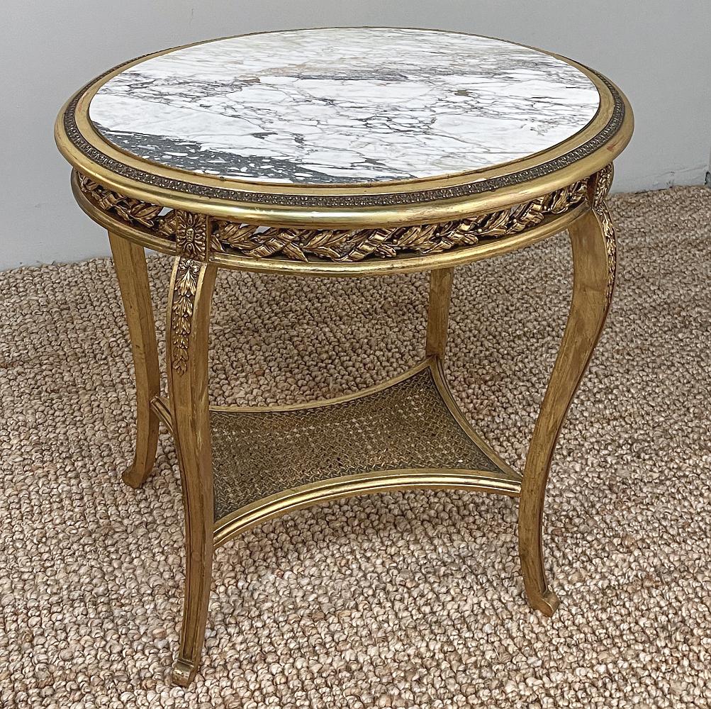 19th century French Louis XVI Gilded marble top end table represents the pinnacle of the Belle Epoque! Designed with an oval shape which is the ultimate in adaptability, it is topped with luxuriously veined marble for carefree beauty. The marble is