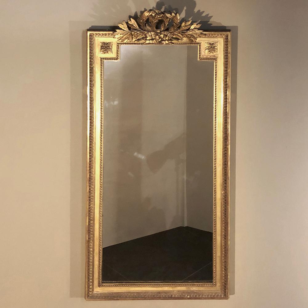 19th century French Louis XVI gilded mirror is always a good choice for tailored decors, whether formal or even somewhat casual. This example is relatively narrow, making it a good choice for a wide variety of applications, from the family room to