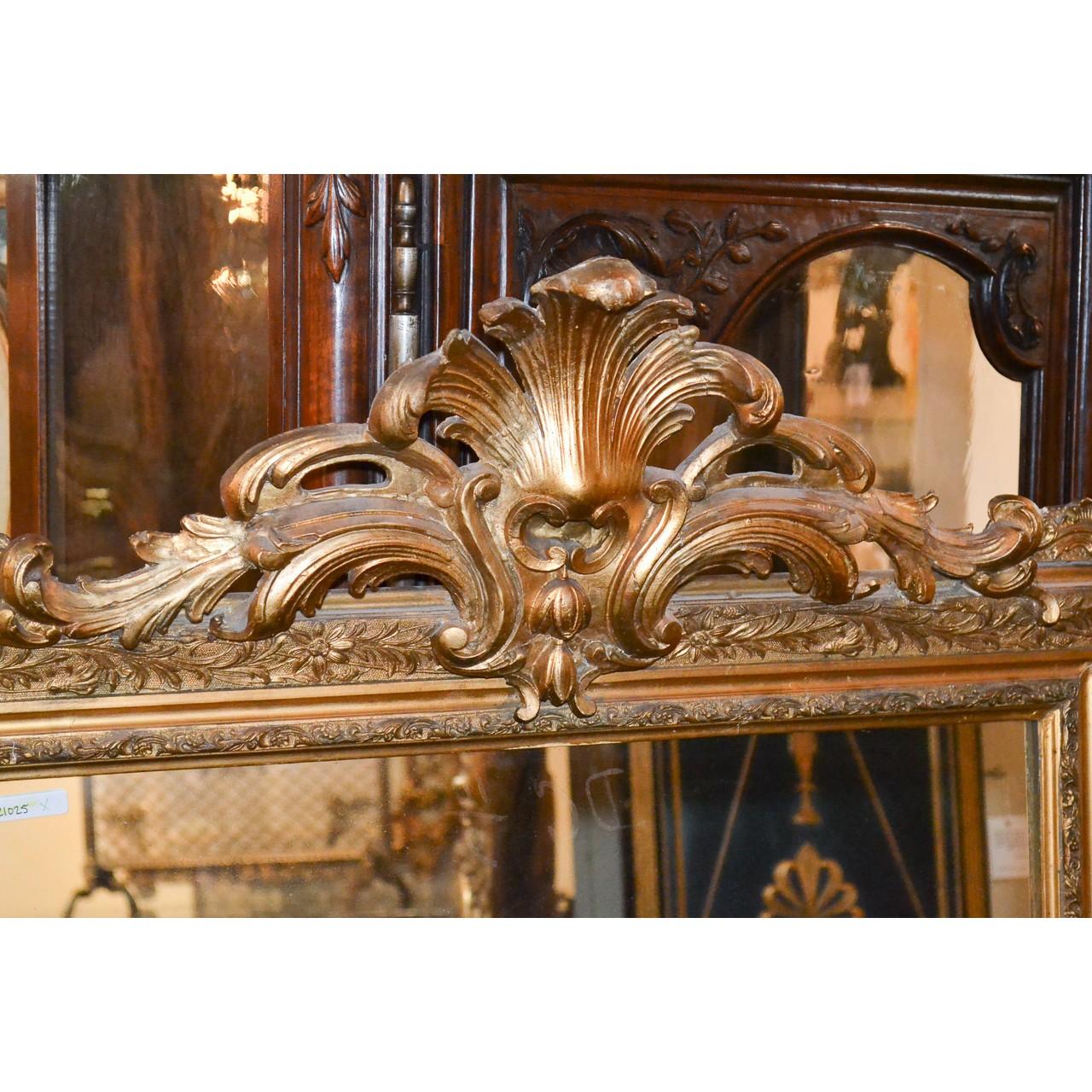 Superb 19th century French Louis XVI style giltwood wall or console mirror with a boldly carved leaf-spray and scrolled acanthus leaf crest. The borders carved in relief with meandering vines and flower heads,

circa 1880.
