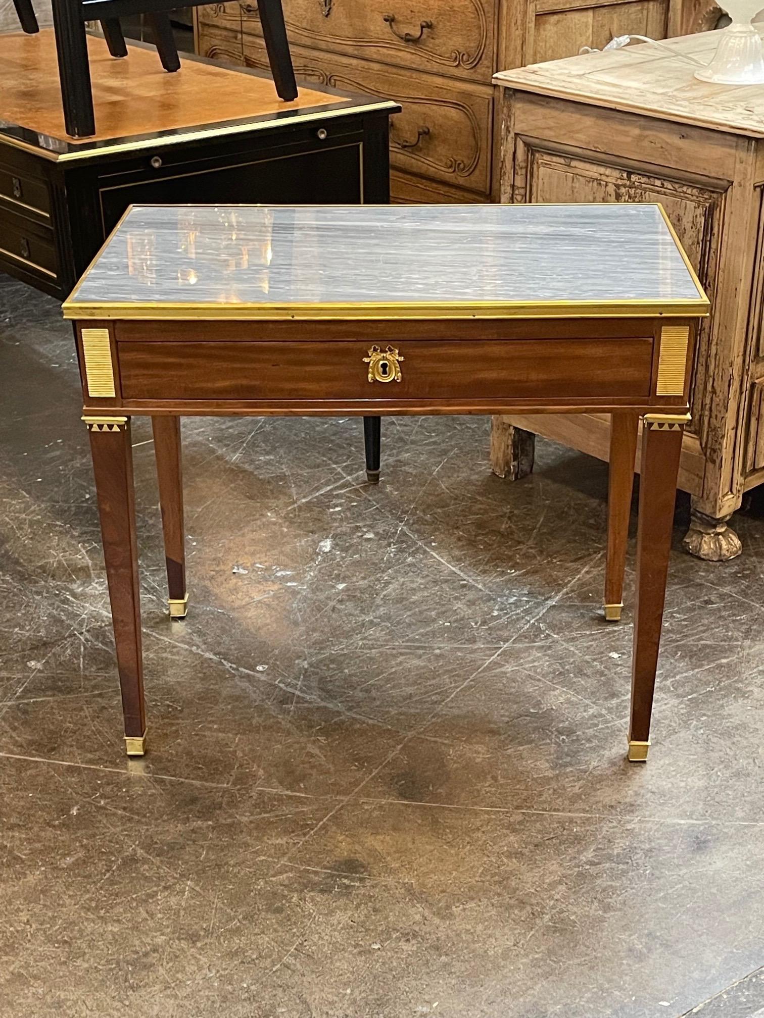 Elegant 19th century French Louis XVI Mahogany and brass side table. Very pretty finished polished wood and inlaid gray colored marble.