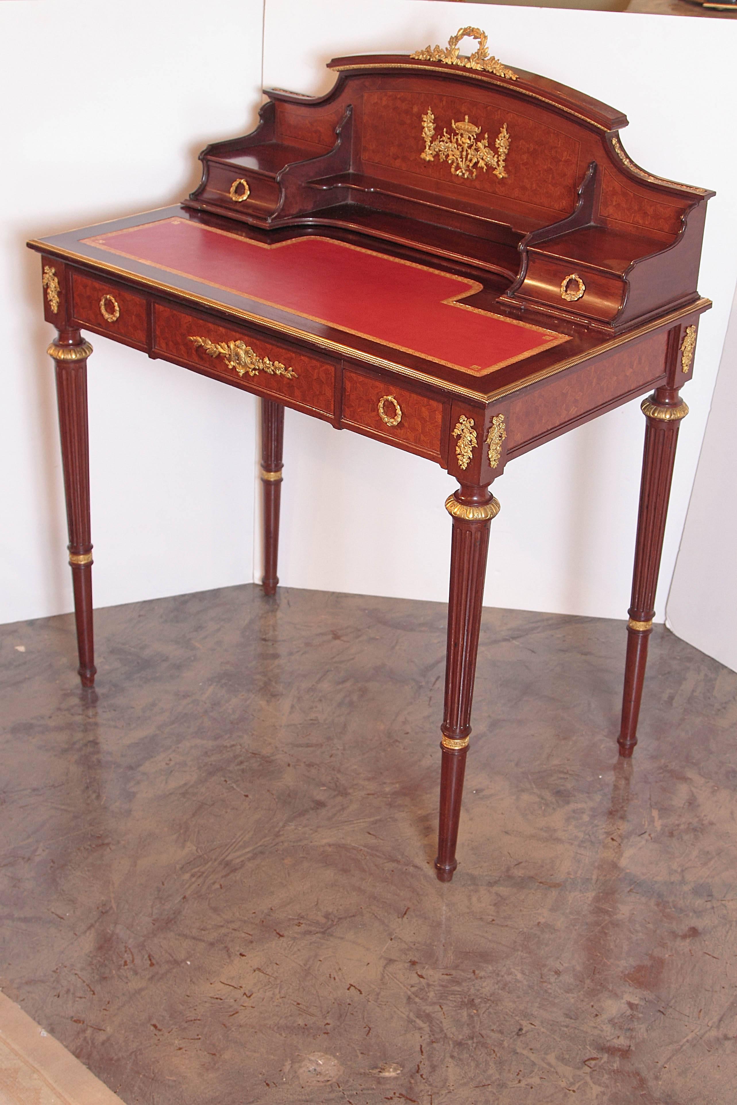 Beautiful 19th century French mahogany and parquetry inlayed French Louis XVI two tiered writing desk. Fine gilt bronze detail. Leather writing surface. Lockplate signed CT LINKE with an index number.