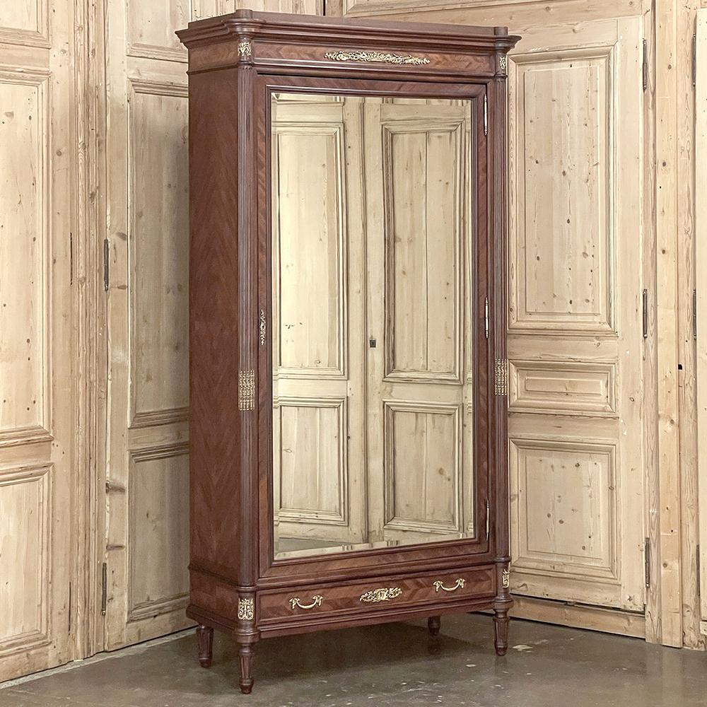 19th Century French Louis XVI Mahogany Armoire with Bronze Mounts from Paris is a stunning example of Belle Epoque grandeur, hand-crafted by masters of a bygone era!  Utilizing exotic imported mahogany, the artisans created a neoclassical casework