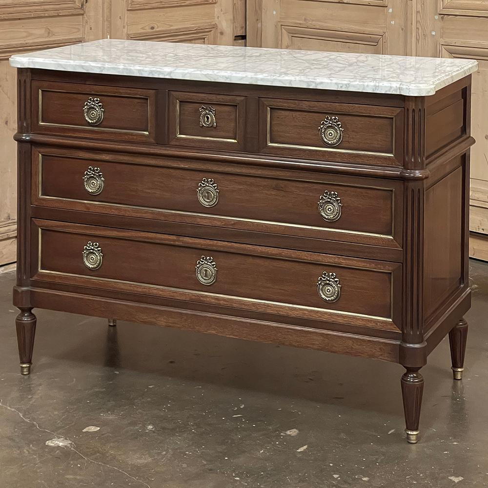 19th Century French Louis XVI Mahogany Commode with Carrara Marble Top represents a revival of the classic style dating back thousands of years!  Inspired by the architecture of the ancient Greeks and Romans, this piece was crafted from fine