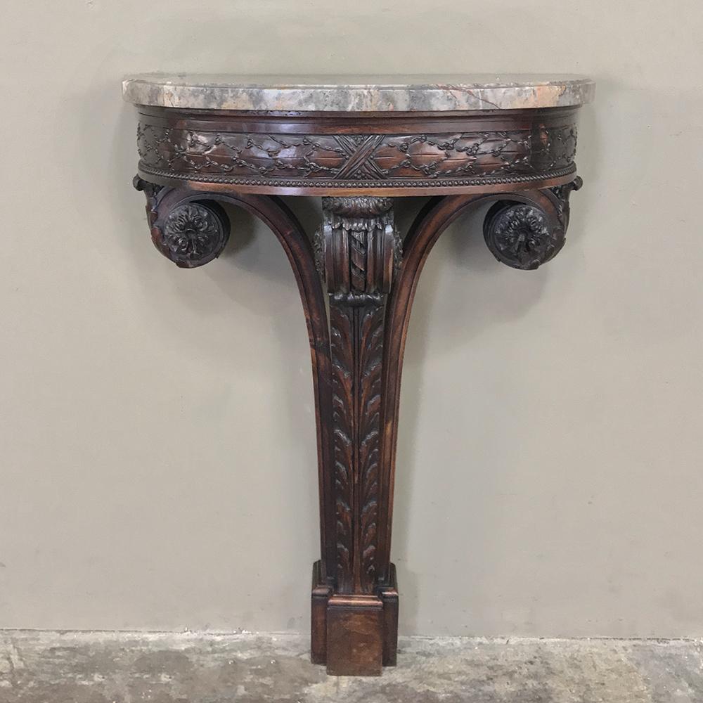 19th century French Louis XVI marble-top demilune console is an exemplary study in the classical form, featuring architecture that dates back to the great masters of ancient Greece and Rome! Graceful curves and glorious hand-carved detail are mated
