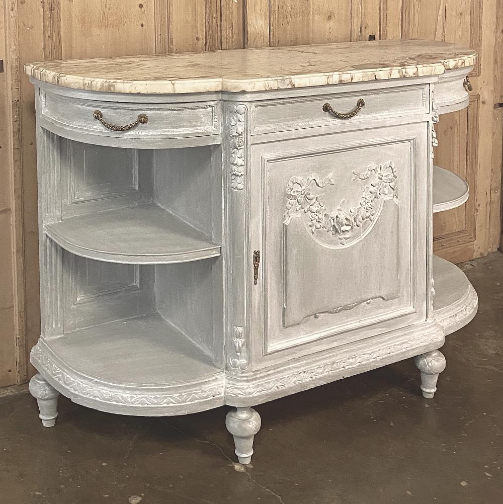 19th century French Louis XVI marble-top painted buffet is over four feet in width but due to the rounded side design, impacts the floor space of your room like a considerably smaller buffet! Fine hand carved detail rendered in solid oak appears on