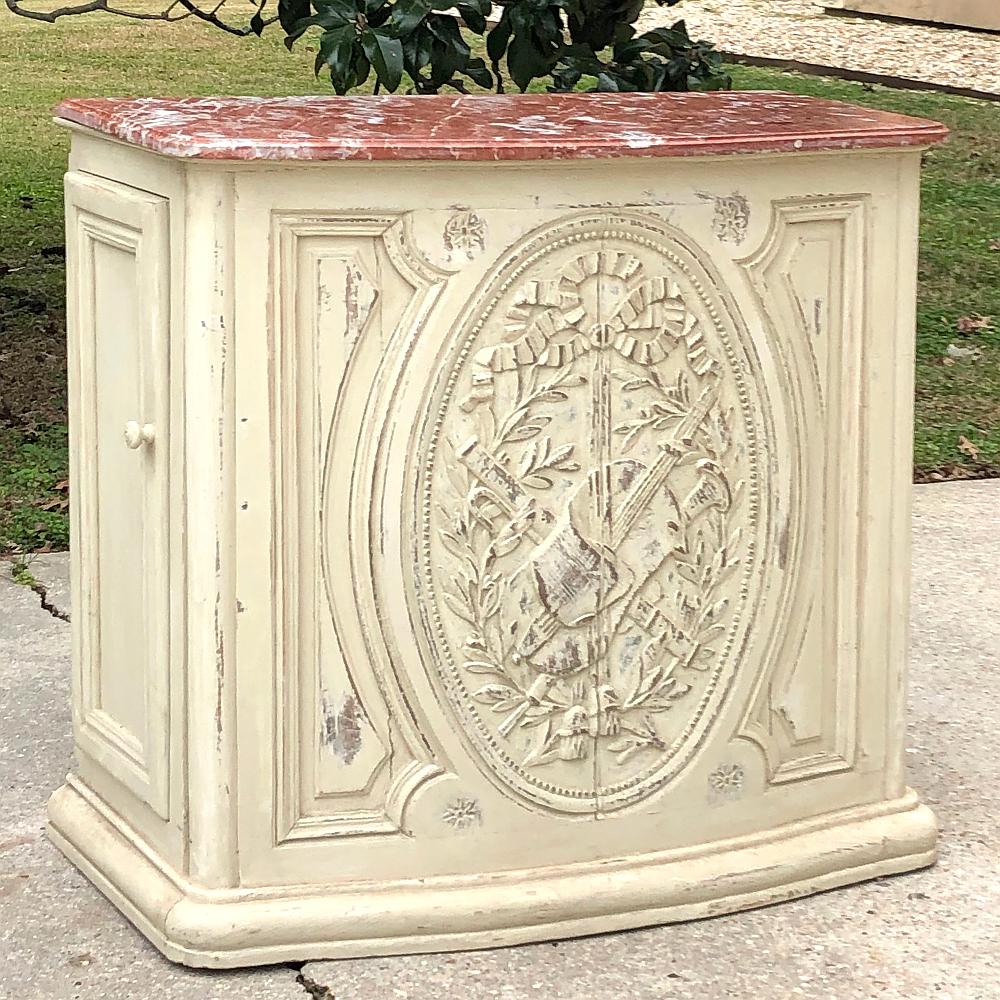 19th Century French Louis XVI marble top painted counter ~ bar is a marvel of craftsmanship and style! The subtle bowfront contours create a visually appealing presence, while the bold molding and astonishing hand-carved bas relief captivate the
