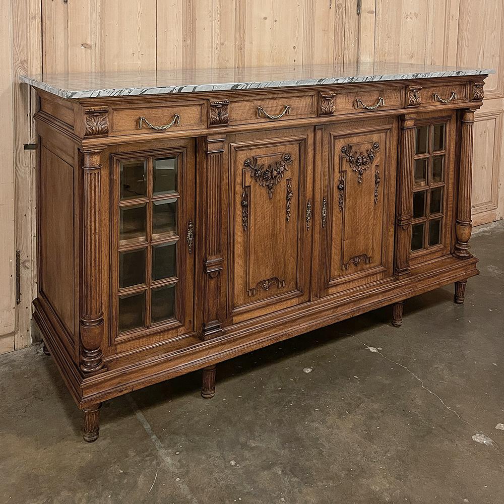 19th Century French Louis XVI Marble Top Walnut Display Buffet is a stunning testament to the extraordinary level of artistry and craftsmanship attained by the master cabinetmakers of France at the fin de siecle.  Utilizing beautifully figured