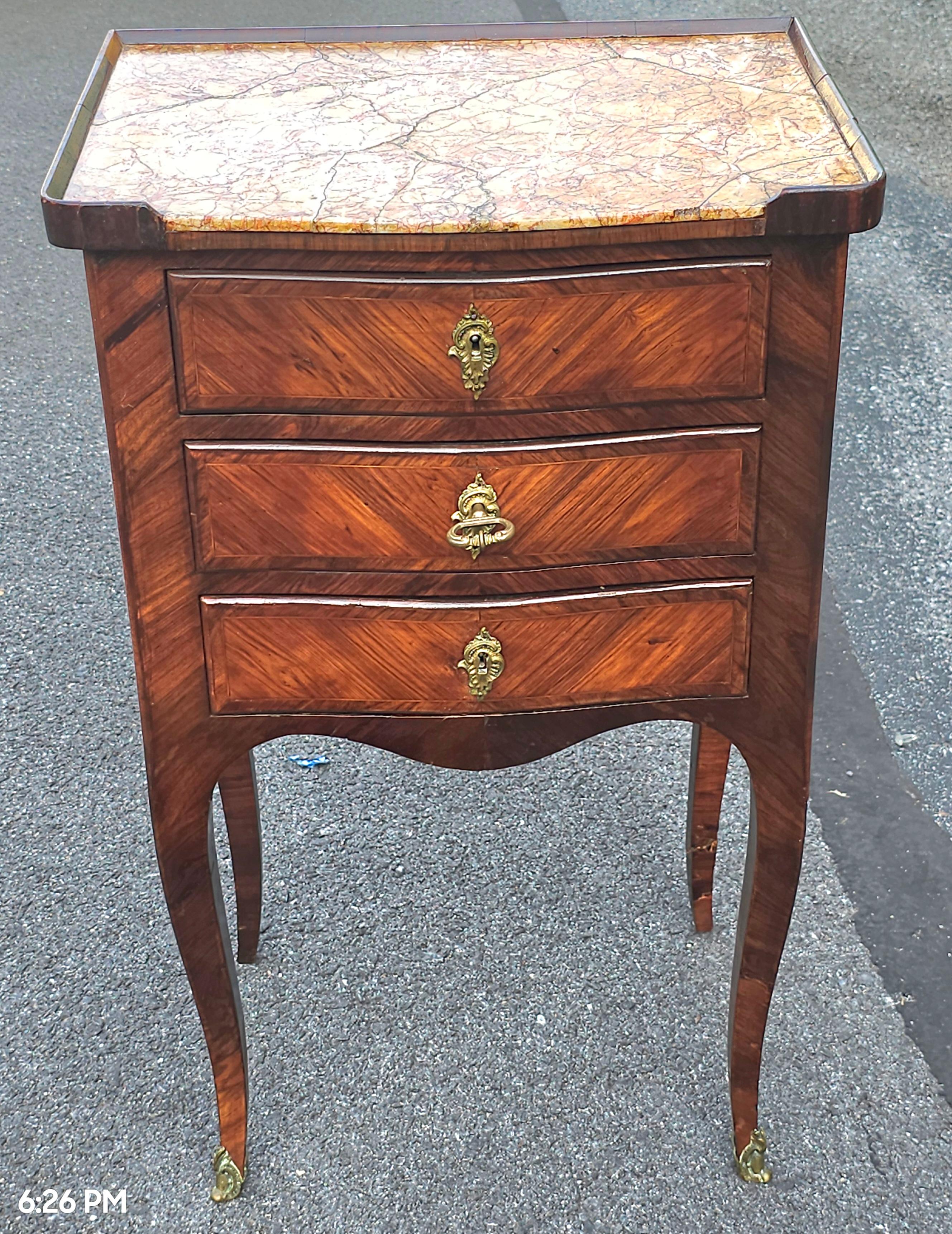 A 19th Century French Louis XVI  Kingwood Marquetry and Marble Insrt Top with Lock and working key for all three flawlessly opening and closing drawers.
17.75
