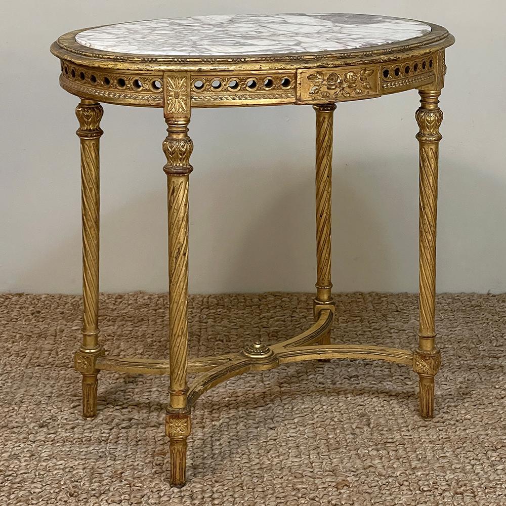 19th Century French Louis XVI Neoclassical Giltwood Marble Top Oval End Table represents the essence of the Belle Epoque, a particularly prosperous time in world history that saw the proliferation of finely crafted furniture created by an equally