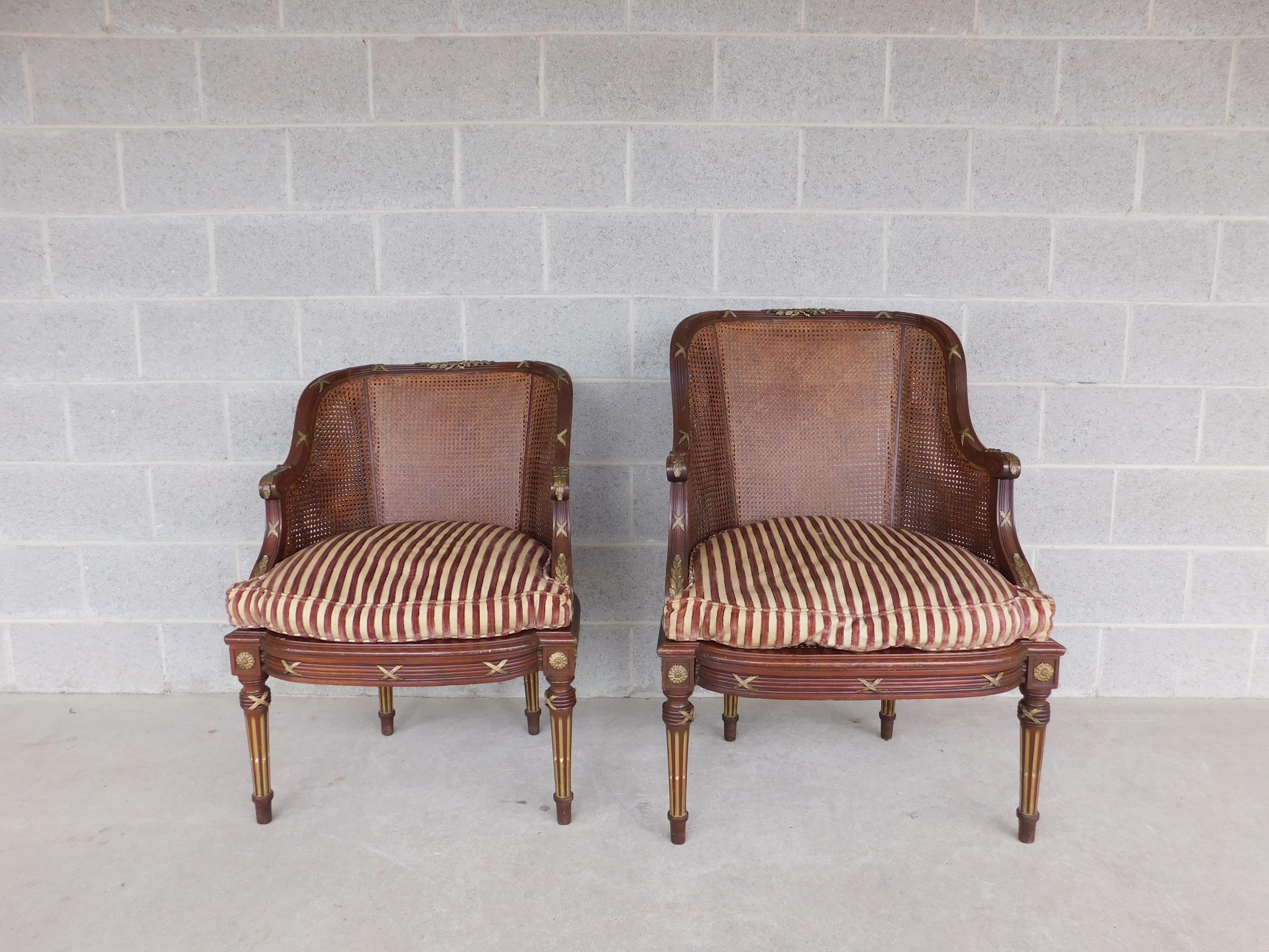circa early 19th century French Louis XVI Ormolu Mounted Accent Bergere Chairs, Caned Barrel Form Front and Back of the Back Rest, Caned Seat Bottom, Loose Chanelle Type Material Down Filled Cushion, Detailed Bronze Mounted Bow Tied Laurel Motif on