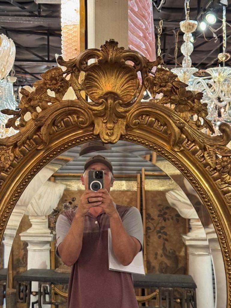Exceptional 19th century French Louis XVI carved and giltwood oval mirror. Featuring an elaborate crest at the top. Lovely! Circa 1870
28w x 44h