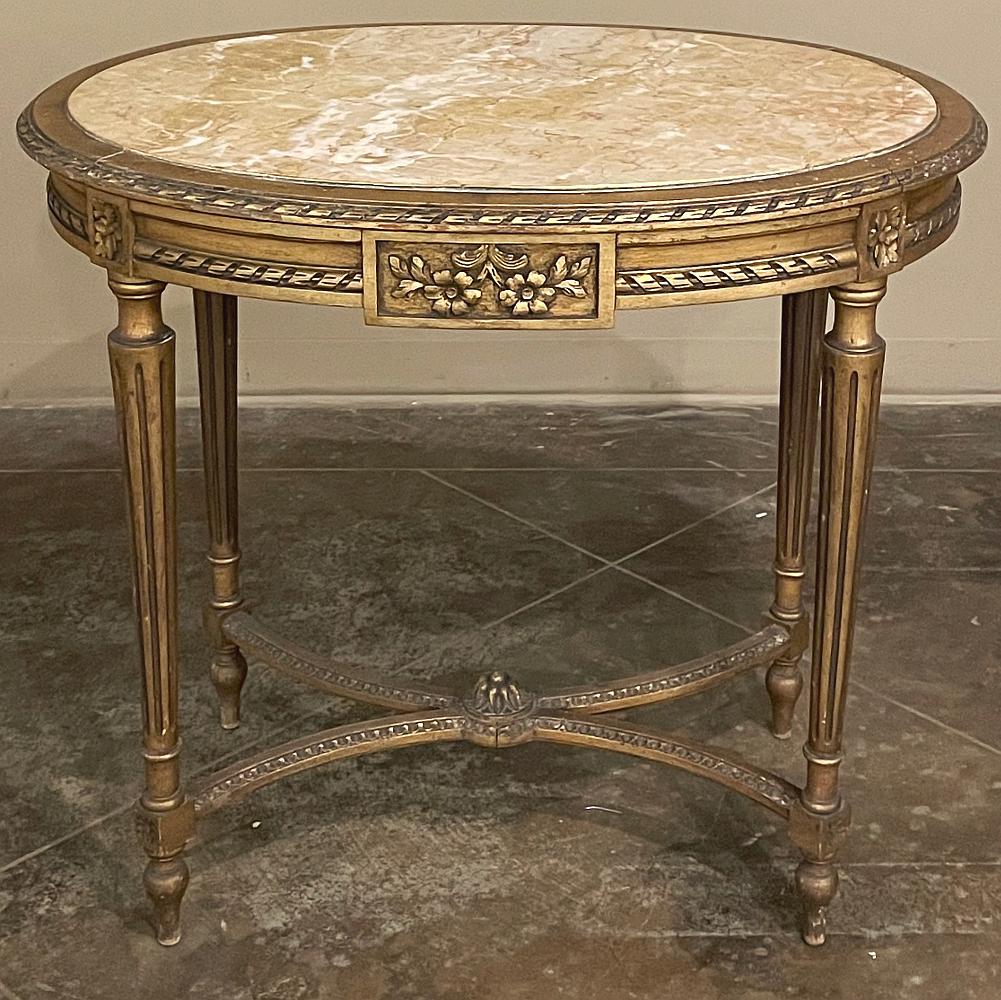 19th century French Louis XVI oval marble top giltwood end table represents a gift from the Belle Epoque, reviving the classical style as only the French can produce! The oval shape makes it compatible, depending on orientation, with just about any
