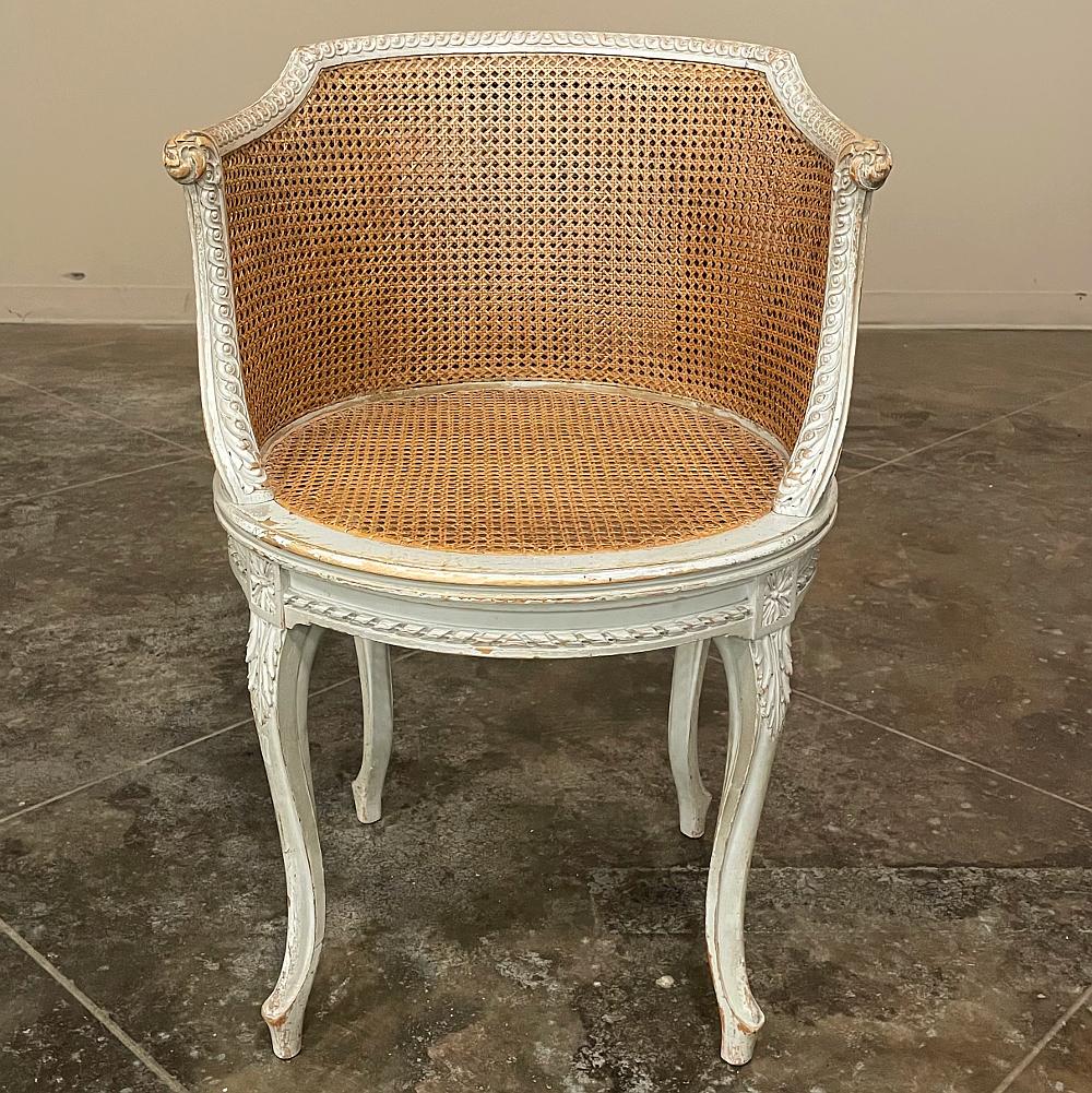 19th Century French Louis XVI painted armchair ~ Bergere is a great choice for occasional use anywhere in the home! Four subtly scrolled cabriole legs carved with acanthus plumes provide support, with an apron encircled with spiral ribbon and