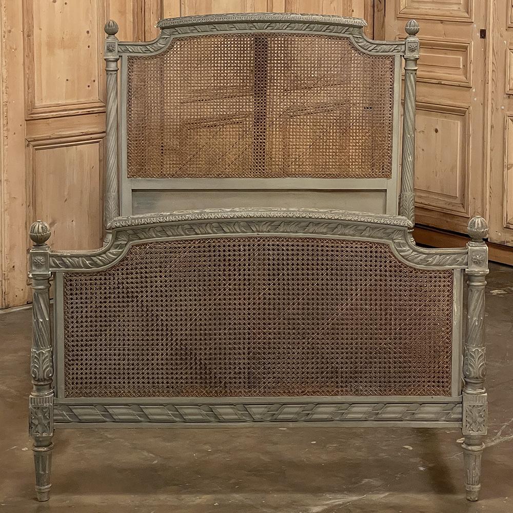 19th Century French Louis XVI painted bed with caning is a splendid example of what some have called 'Paris Country' where a refined style is made more casual primarily by a finish treatment. Produced by Hopilliart & Leroy in Paris, it ably