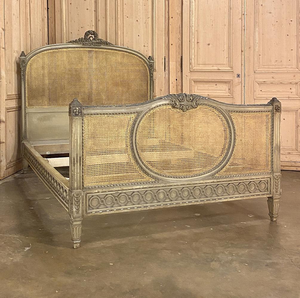 19th century French Louis XVI painted and caned Queen bed is a masterpiece of the wood sculptor's art! Classic architecture and French artistry combine to create a visual feast for the eyes, with the incredible added bonus that our expert in-house
