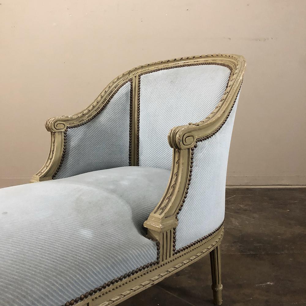 19th century Louis XVI painted chaise longue is a study in elegance and comfort! Wraparound upholstered seatback allows one to relax in style, with handcarved framework embellished with acanthus leaf, spiral ribbon and beaded detailing, all