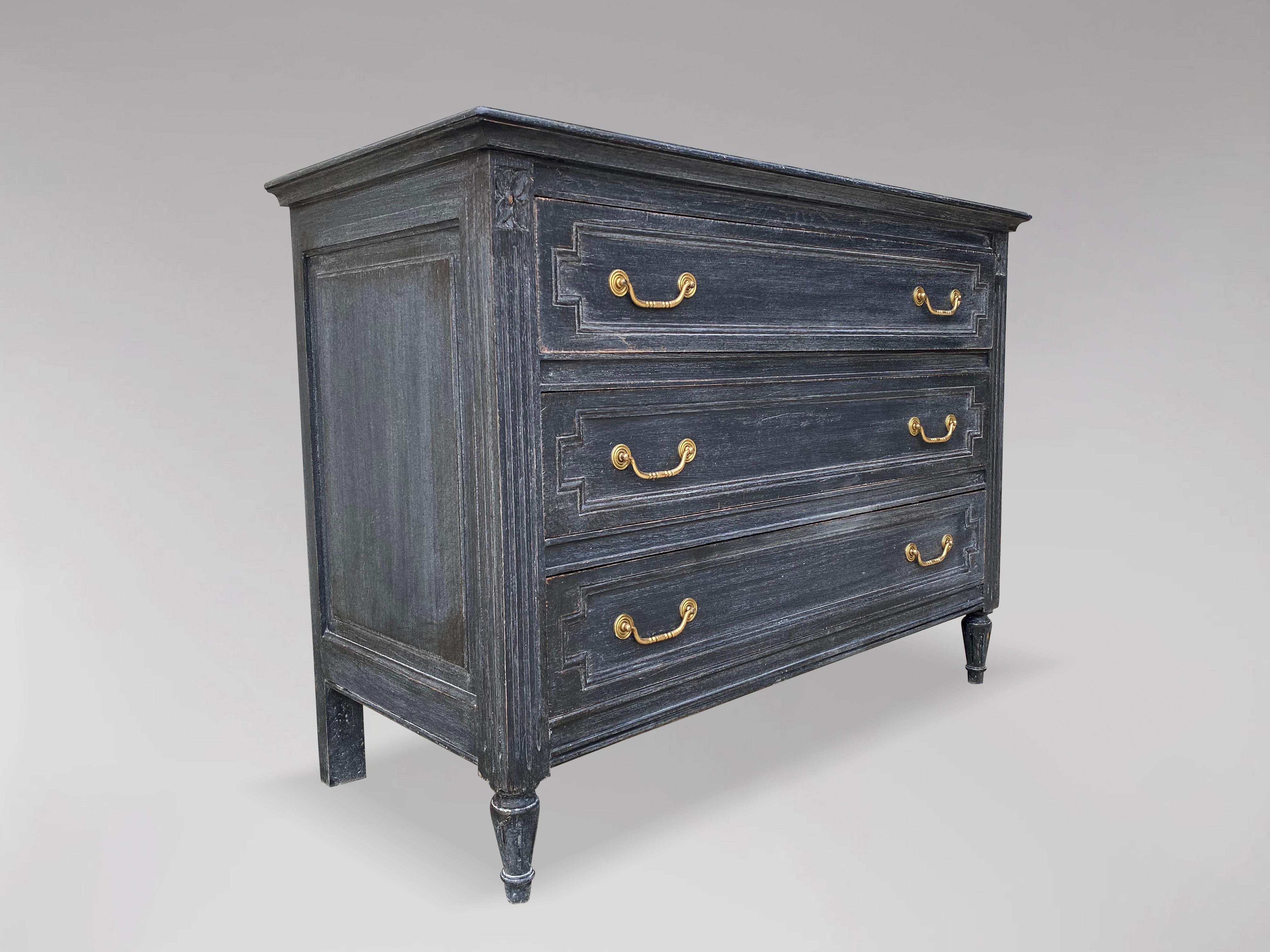 An attractive late 19th century French provincial Louis XVI style painted commode or chest of drawers. Having a wonderfully distressed blue gray painted finish with dark charcoal accents, circa 1890s. Rectangular moulded top above a set of three