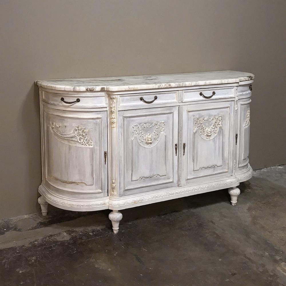 19th century French Louis XVI painted marble top buffet is over six feet in width but due to the rounded side design, impacts the floor space of your room like a 5 foot wide buffet! Fine hand-carved detail rendered in solid oak appears on the main