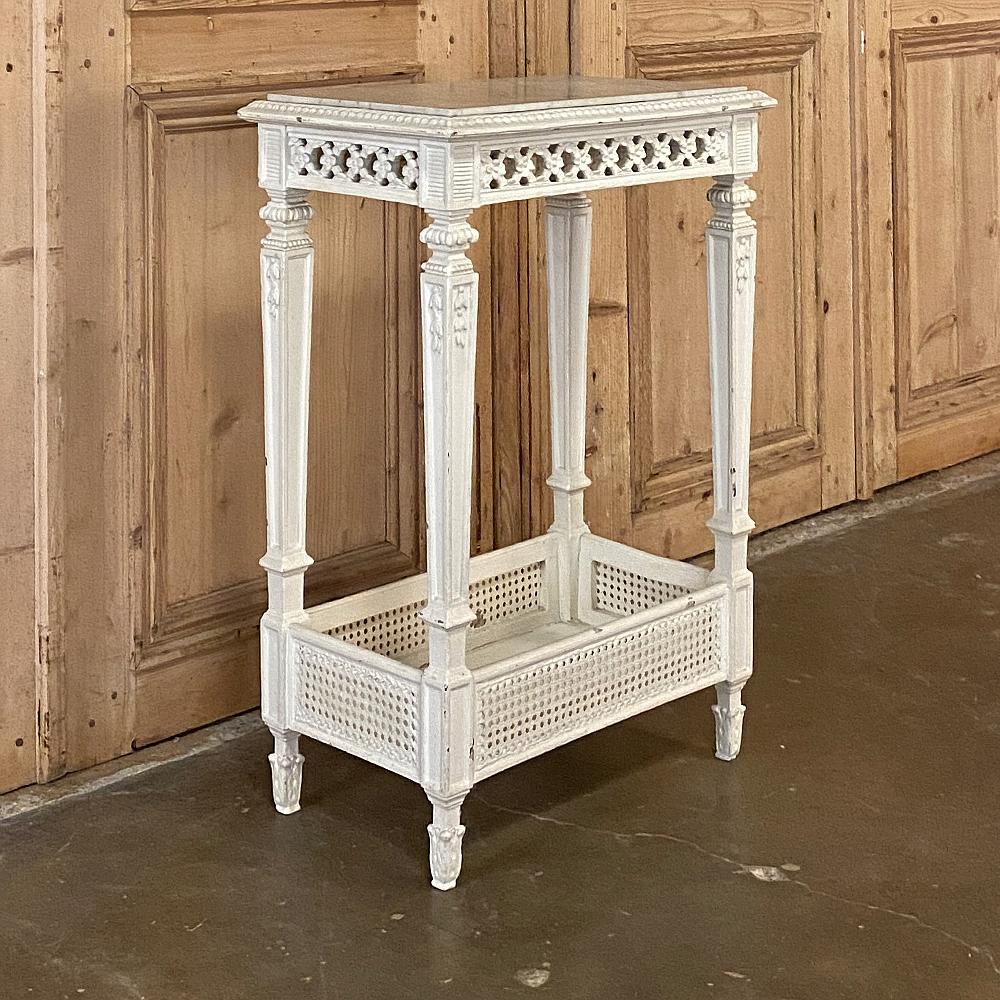 19th century French Louis XVI painted marble-top end table combines classical design with masterful French craftsmanship to create a table that will catch anyone's eye! A floral latticework has been pierce-carved into the apron on all four sides,