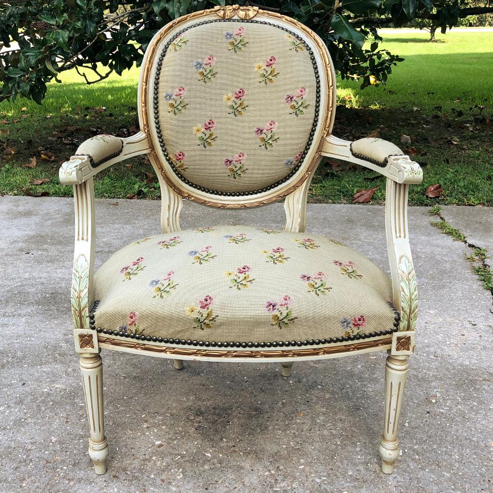 19th century French Louis XVI painted needlepoint armchair is a study in classical elegance! The hand-carved framework features a contoured, oval seatback and generously sized seat, all upholstered in painstakingly crafted needlepoint tapestry. The