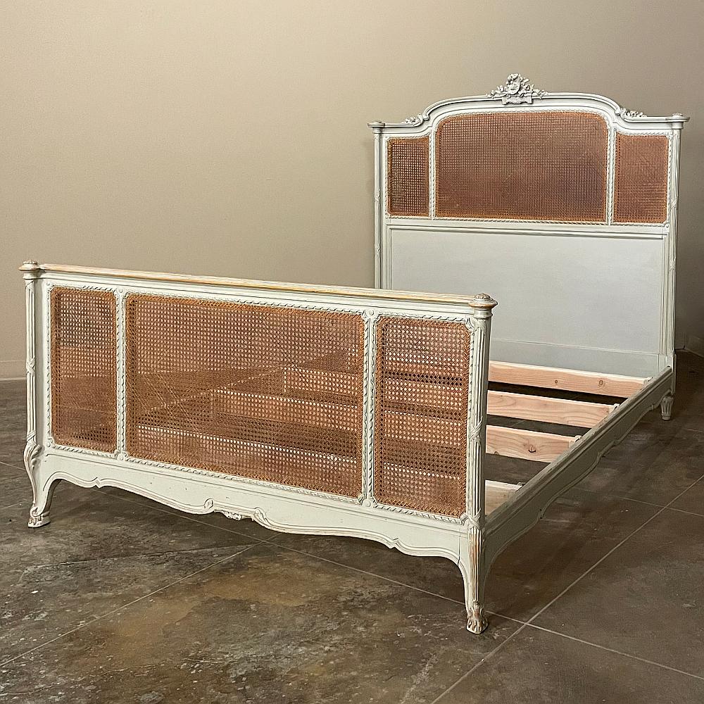 19th century French Louis XVI painted queen bed is a splendid combination of style, form and function! Hand-crafted from imported mahogany, it has been elegantly carved to reflect the neoclassical revival style, and finally painted in an ivory white