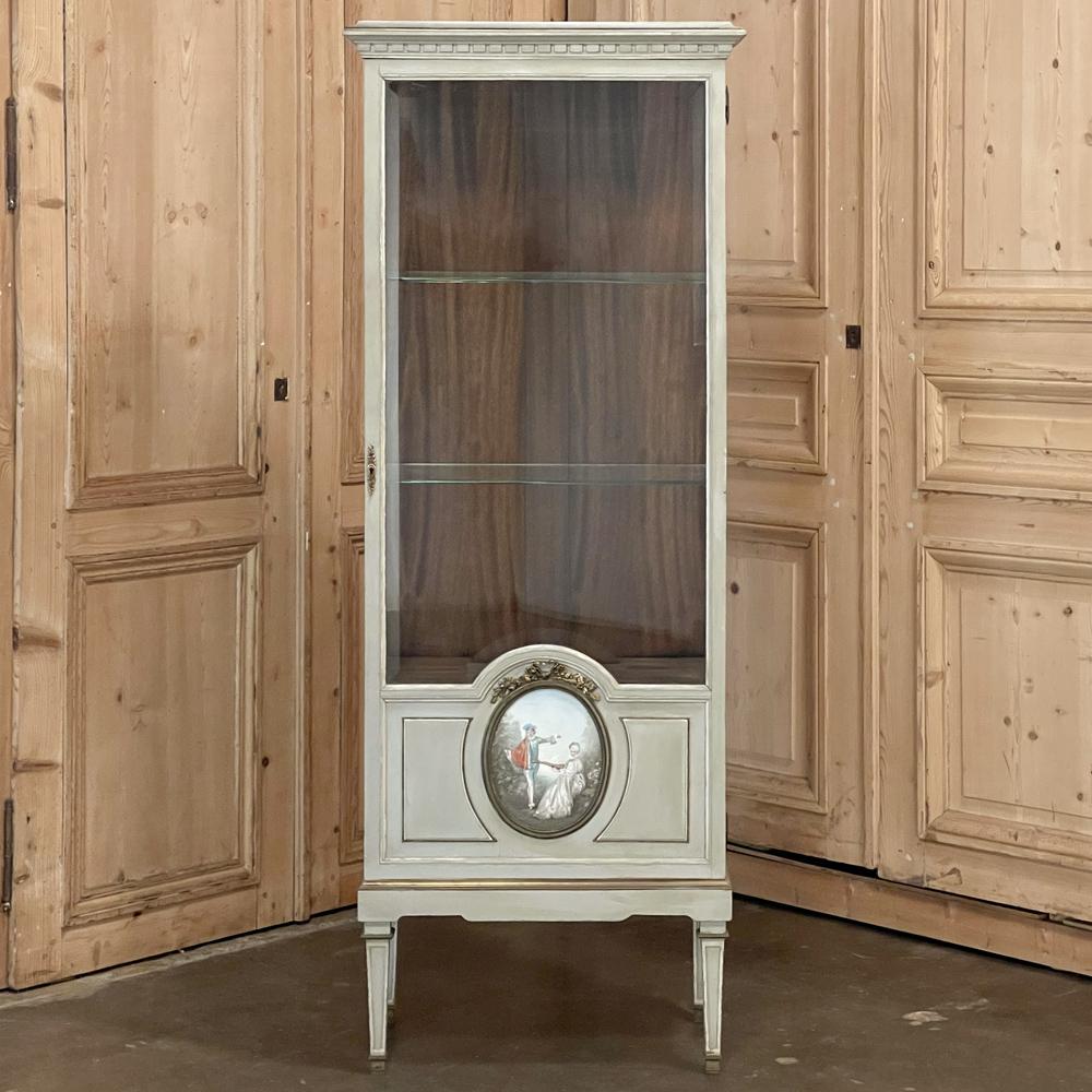 The French vitrine reached a pinnacle of style during the second half of the 19th century, as evidenced by this charming and superlative 19th Century French Louis XVI Painted Vitrine. Featuring its original painted finish that has achieved a lovely