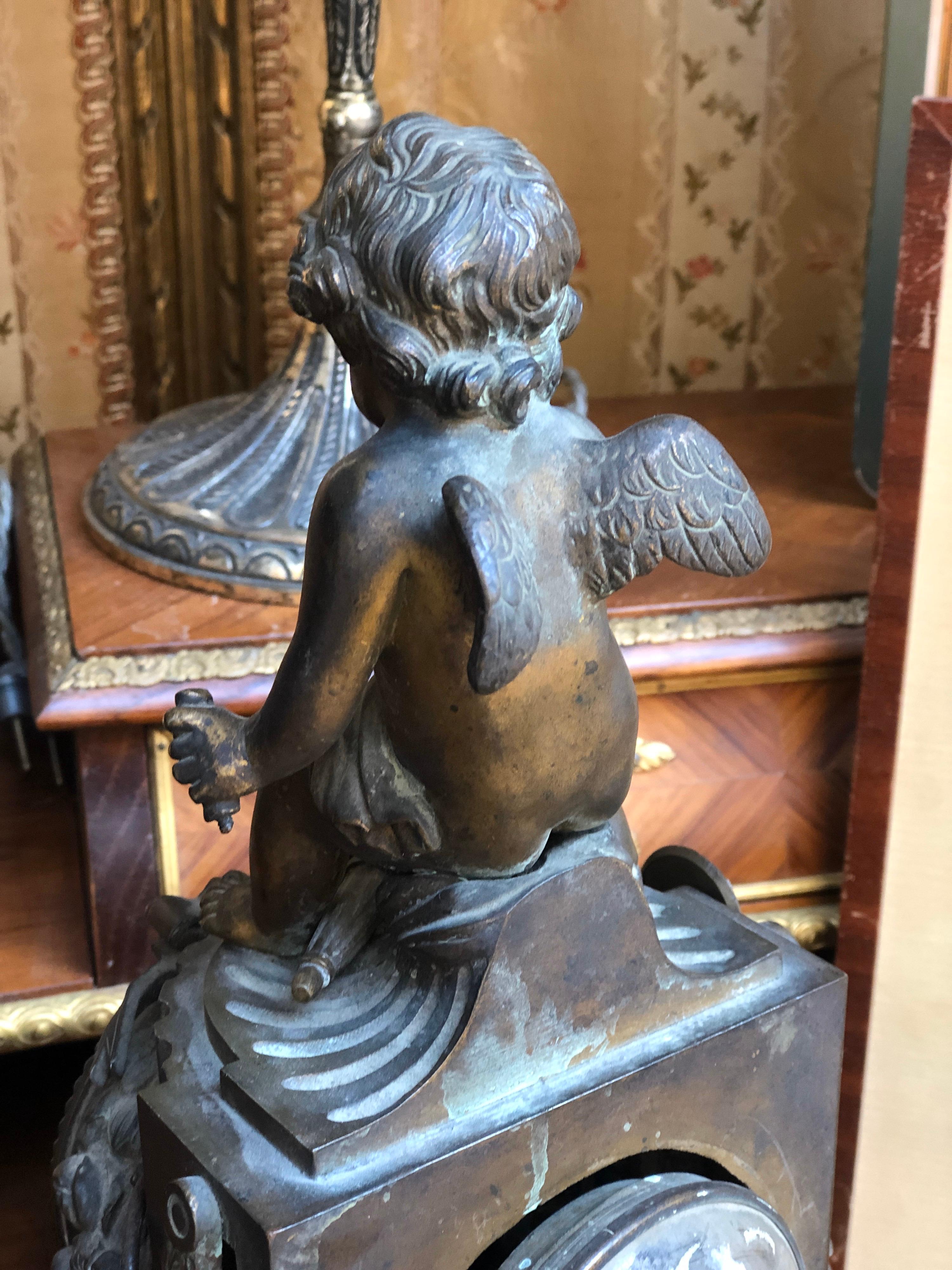Bronze 19th Century French Louis XVI Patinated Table Clock with a Figure of a Cupid For Sale