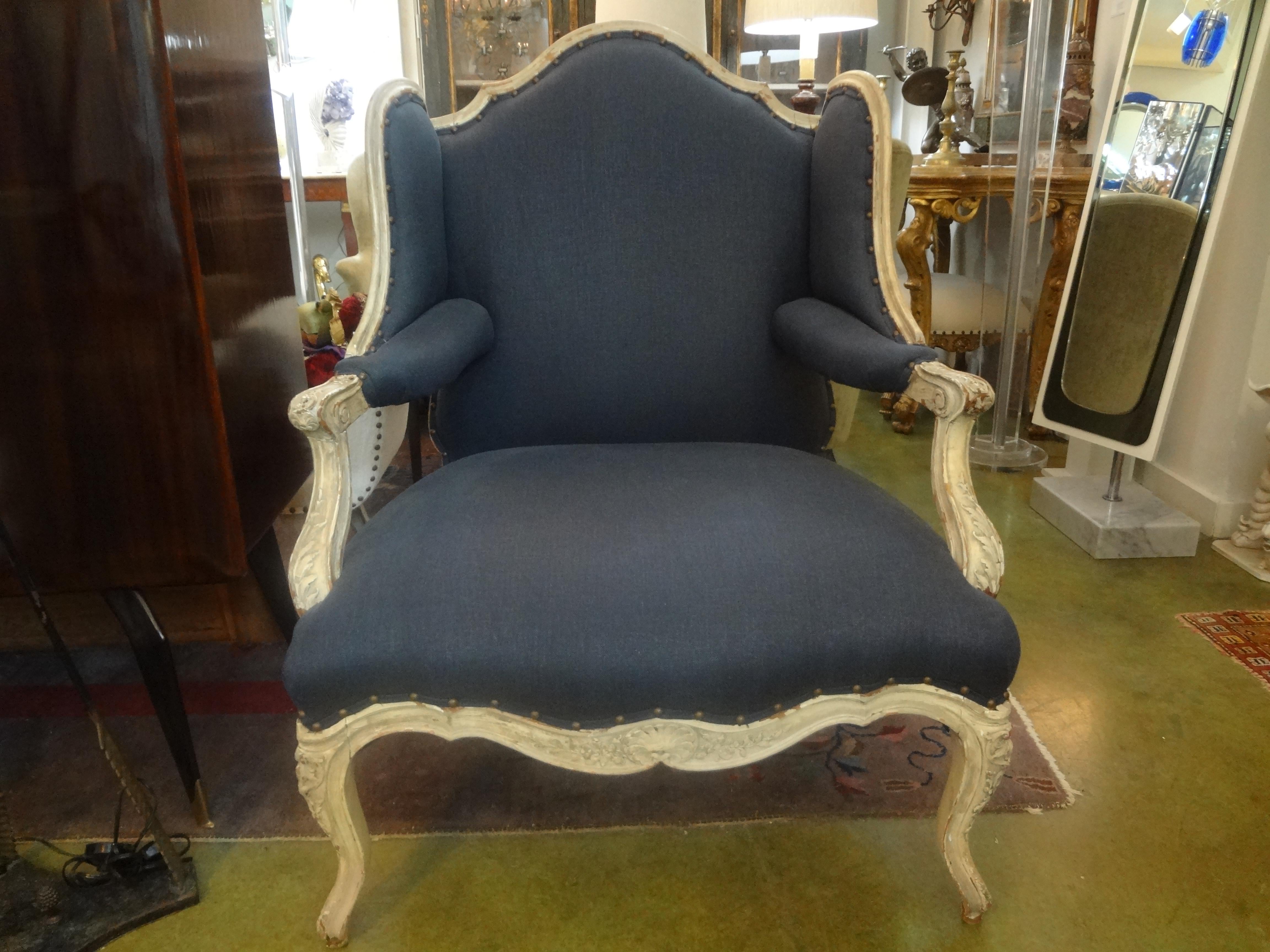 Stunning 19th century French Régence style fauteuil. This beautiful and comfortable antique painted French Regence style or Louis XVI style armchair, bergere, marquise or wingback chair has been taken down to the frame and professionally upholstered