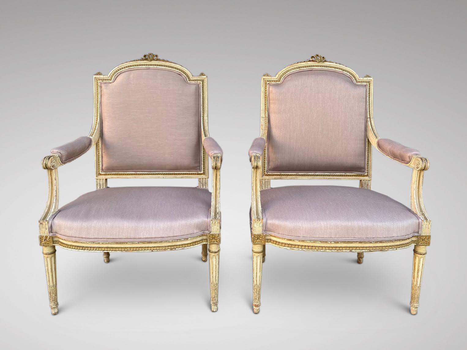 A stunning pair of Louis XVI Style, late 19th century painted, carved and reupholstered armchairs. Original cream coloured carved woodwork, original horse hair filling, hessian covering and newly reupholstered in a quality taupe colour fabric.
 
The