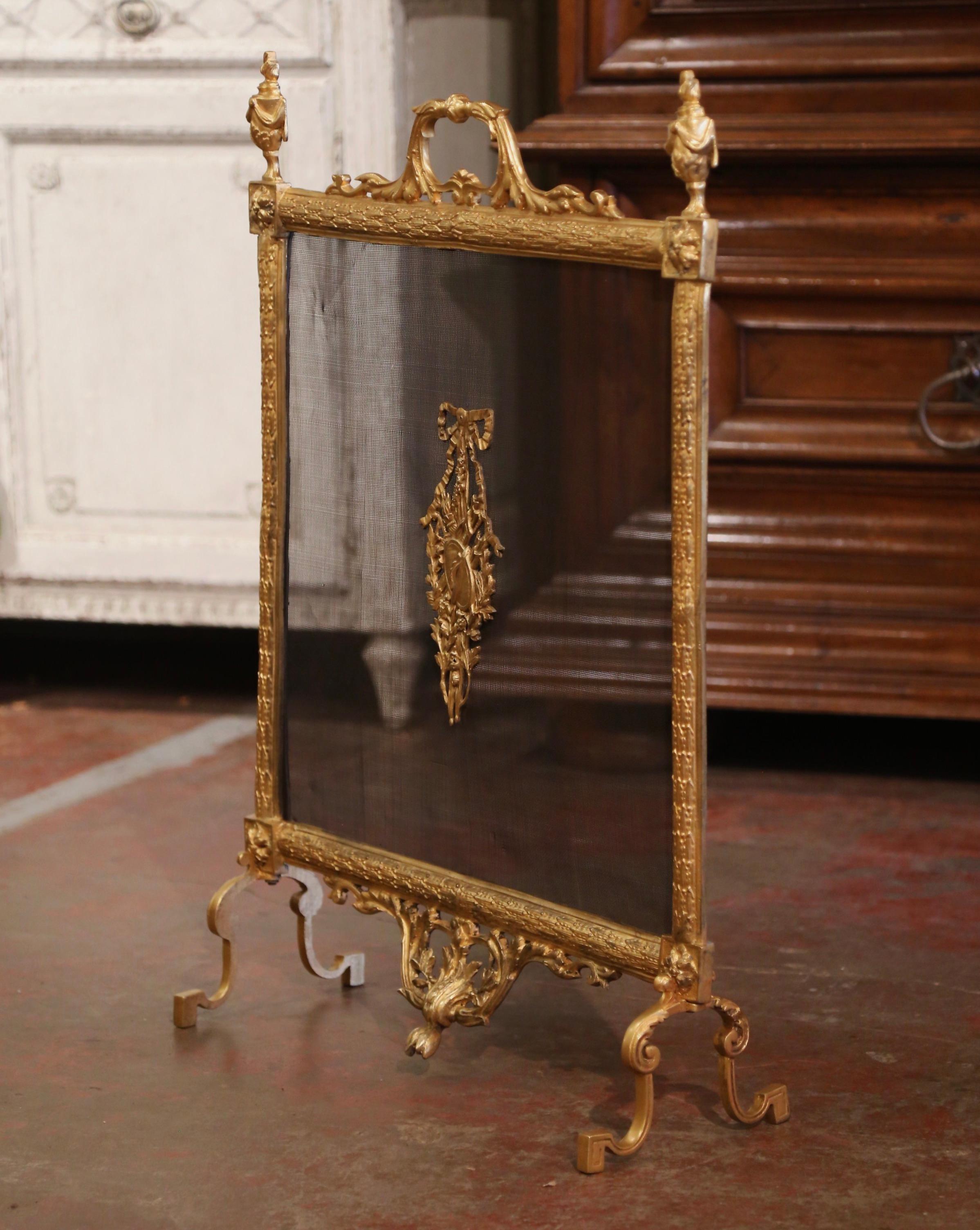 Decorate your fireplace with this elegant antique Parisian screen. Crafted in France circa 1870, the rectangular shaped screen sits on scroll feet decorated with acanthus leaf motifs over a carved and pierced floral apron. With mesh wire on the
