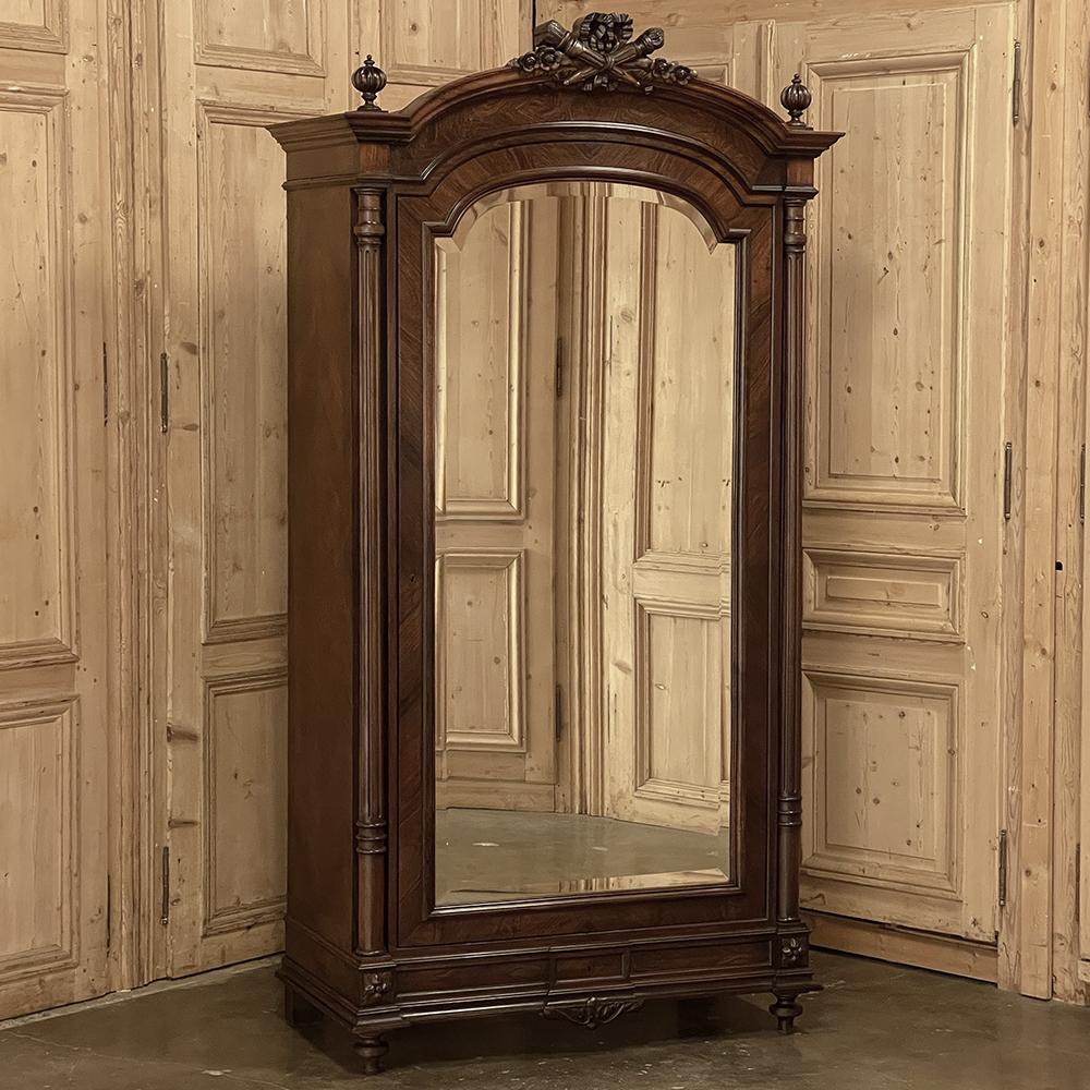 19th Century French Louis XVI Rosewood Armoire brings to life the neoclassical revival that occurred during the reign of Napoleon III.  Executed in exotic imported rosewood, it features veneers with oriented grain patterns to create intriguing