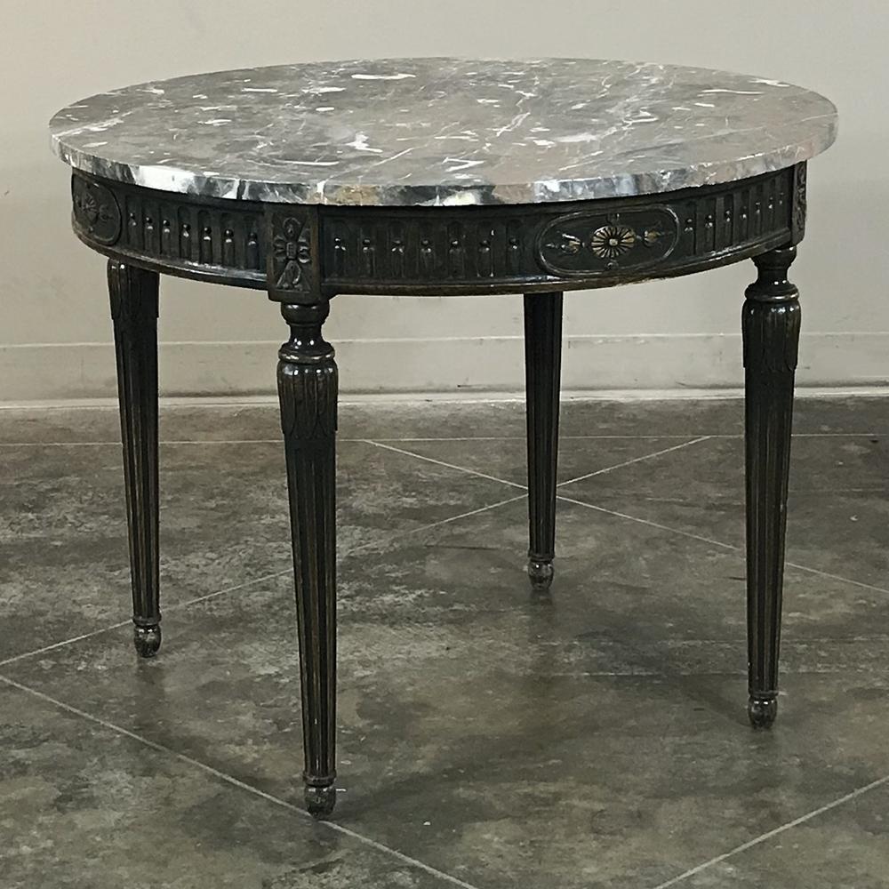 This 19th century French Louis XVI round marble-top table makes the ideal choice for placement in any part of the room, even a corner! Carefree, luxurious marble top rests upon walnut frame finely carved with neoclassical motifs, supported by