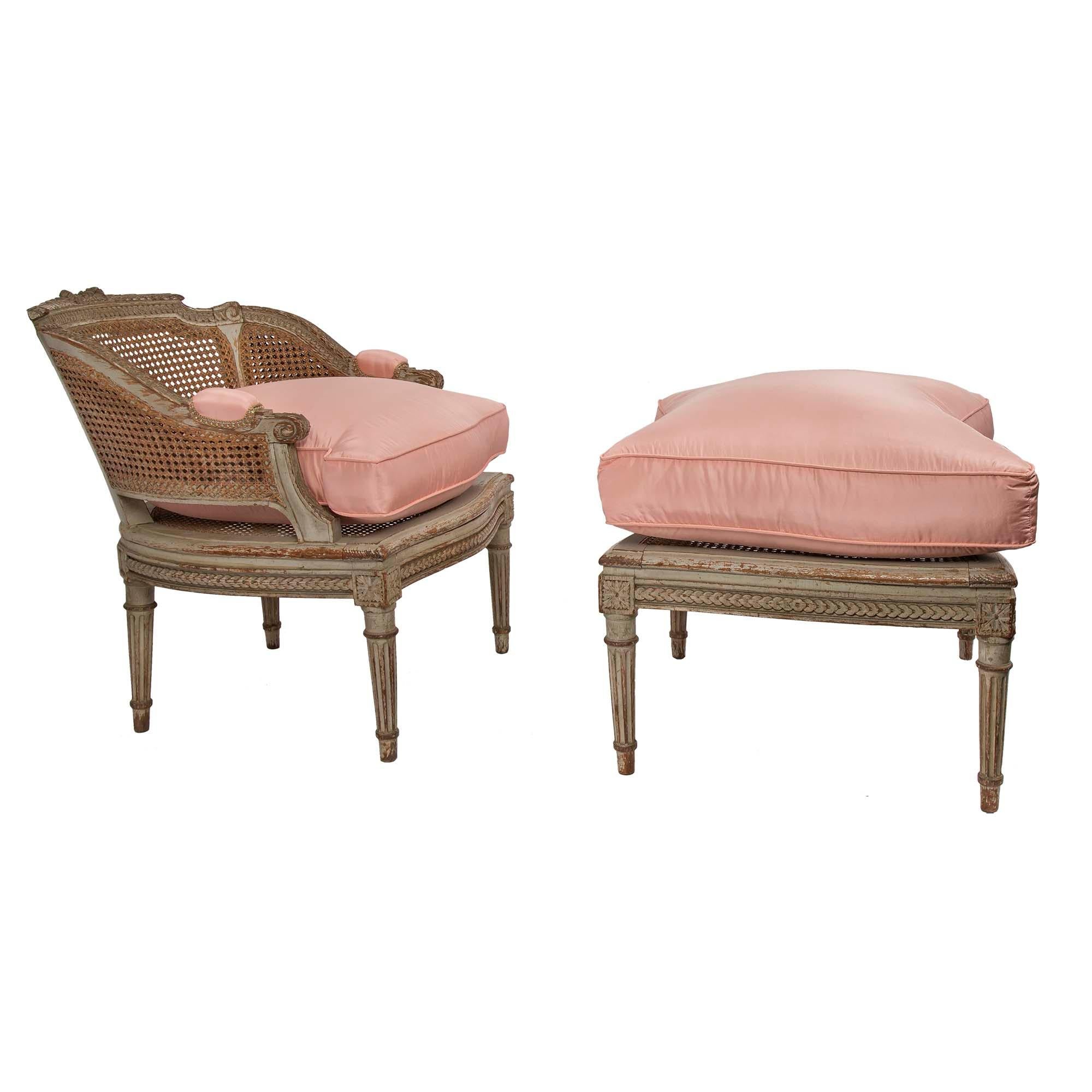 A wonderful 19th century French Louis XVI st. patinated and cane Duchesse Brisée The three piece lady's seating group is raised by tapered fluted legs topped by corner block rosettes. The frieze is finely carved with a foliate band. Each caned