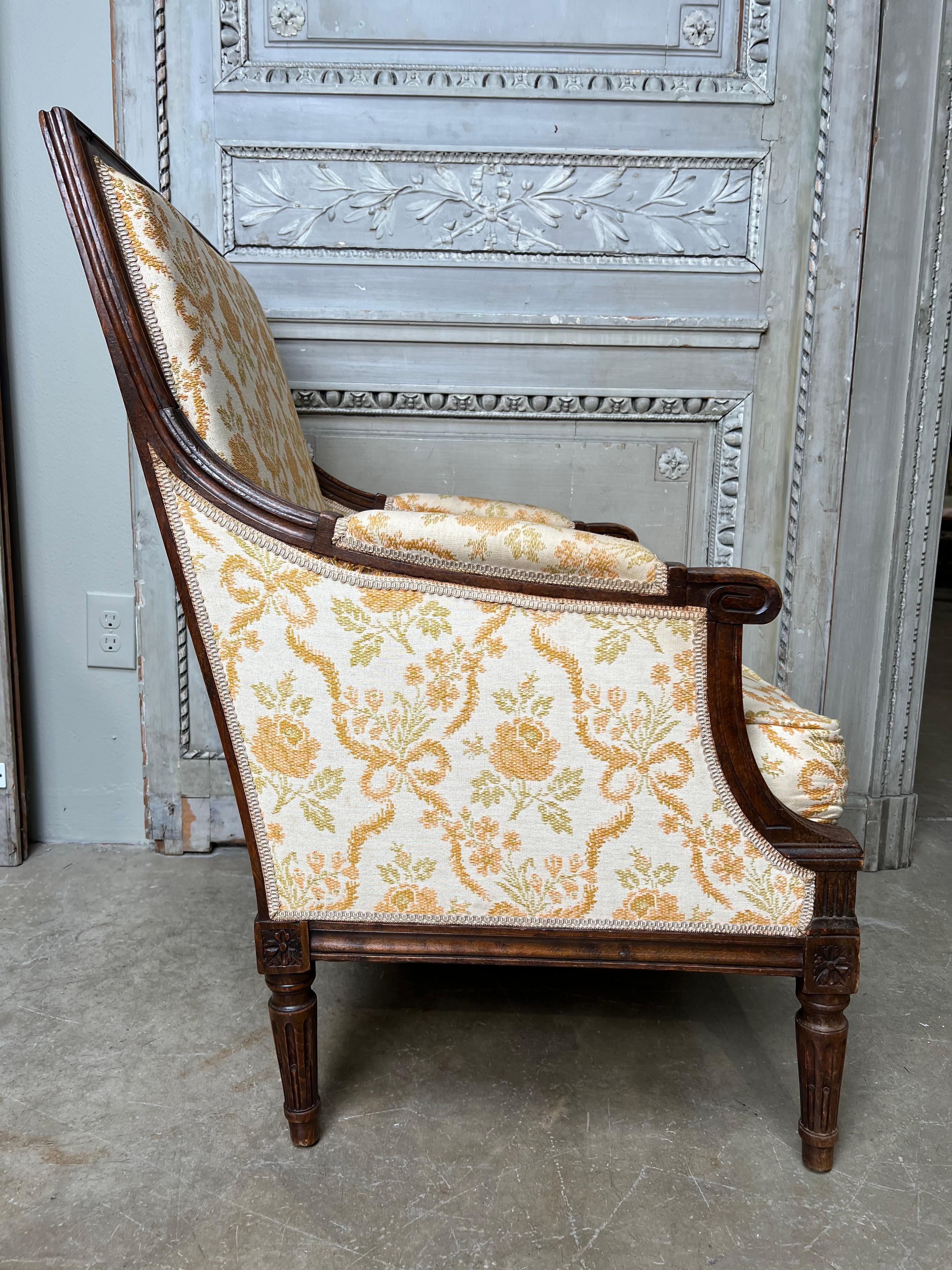A large scale French carved wood Louis XVI style bergere chair.  
This comfortable armchair is very decorative and functional, it is pegged together and very strong, the upholstery is old and can be replaced.  