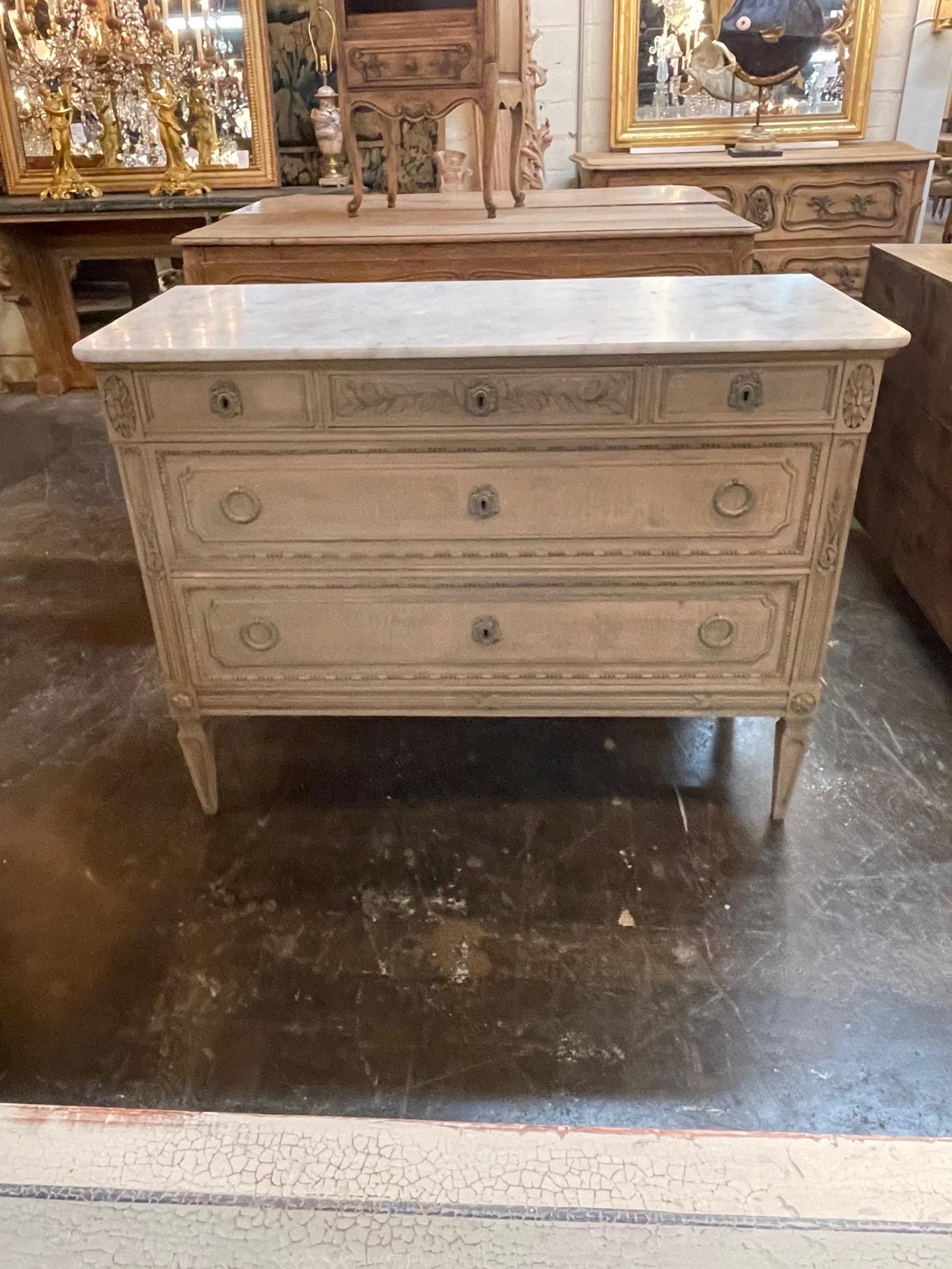 Lovely 19th century French Louis XVI style bleached commode with carrara marble top. Very fine patina and carvings. This piece also mixes well with a variety of style. Superb!