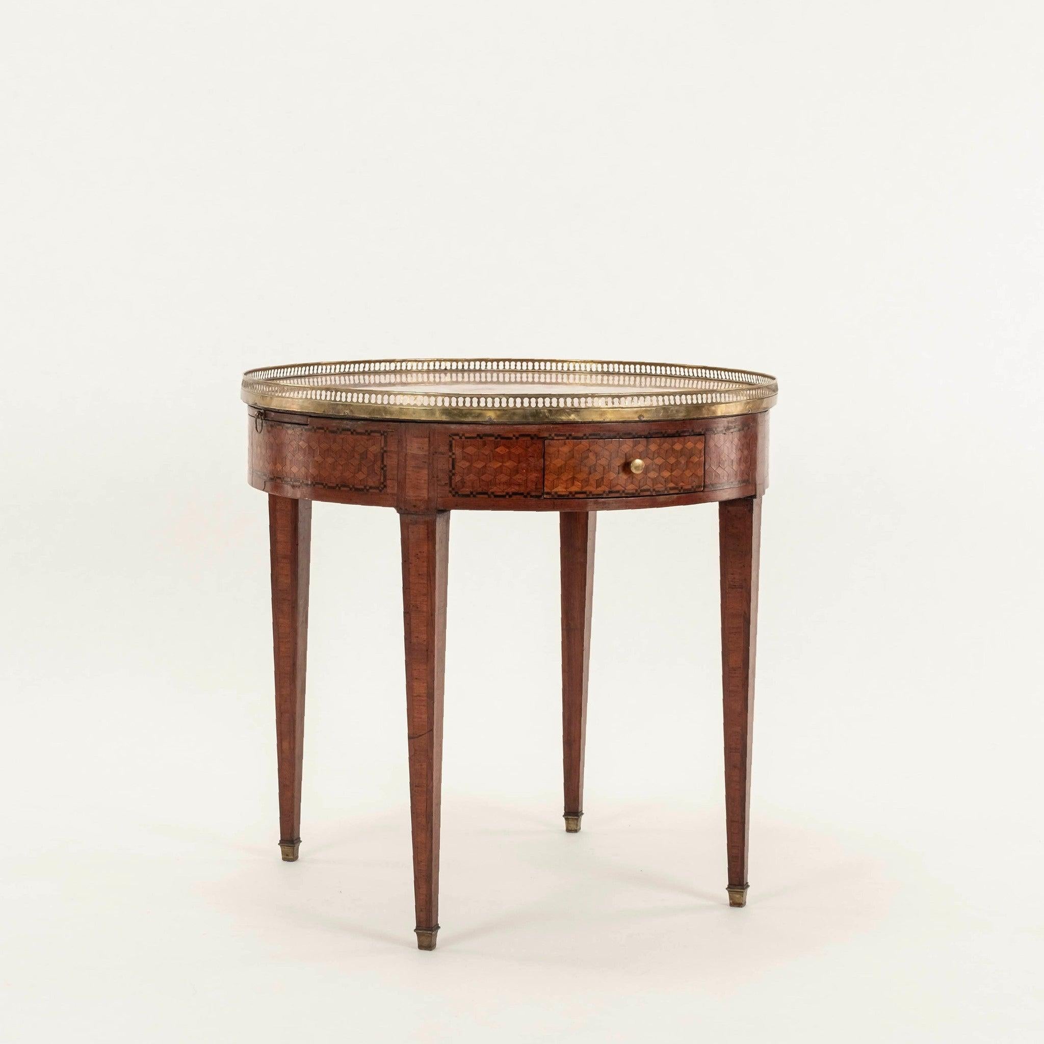 19th Century French Louis XVI style Bouillotte table crafted with rich mahogany marquetry, marbled top, bronze gallery, two pull out leaves, and two drawers, each accented with bronze pulls.