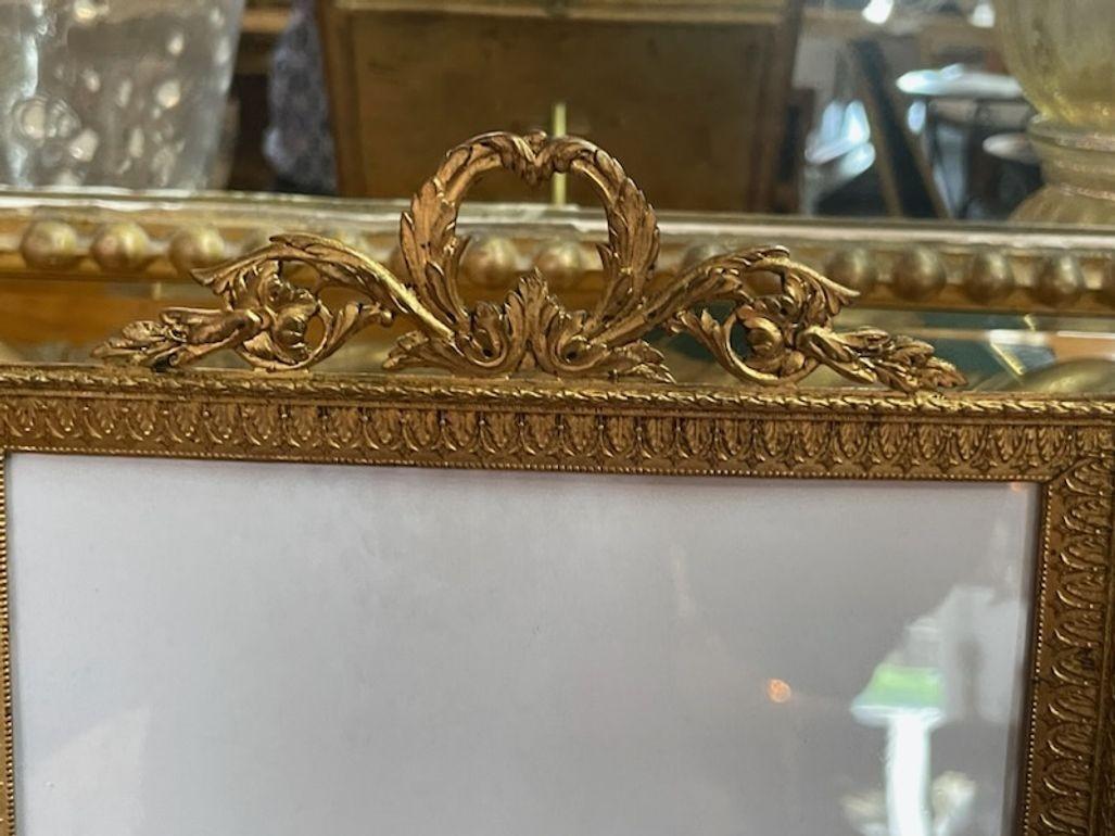 Exquisite 19th century French Louis XVI style Bronze Dore picture frame.  Lovely details including a crest at the top. Very nice!! Circa 1880