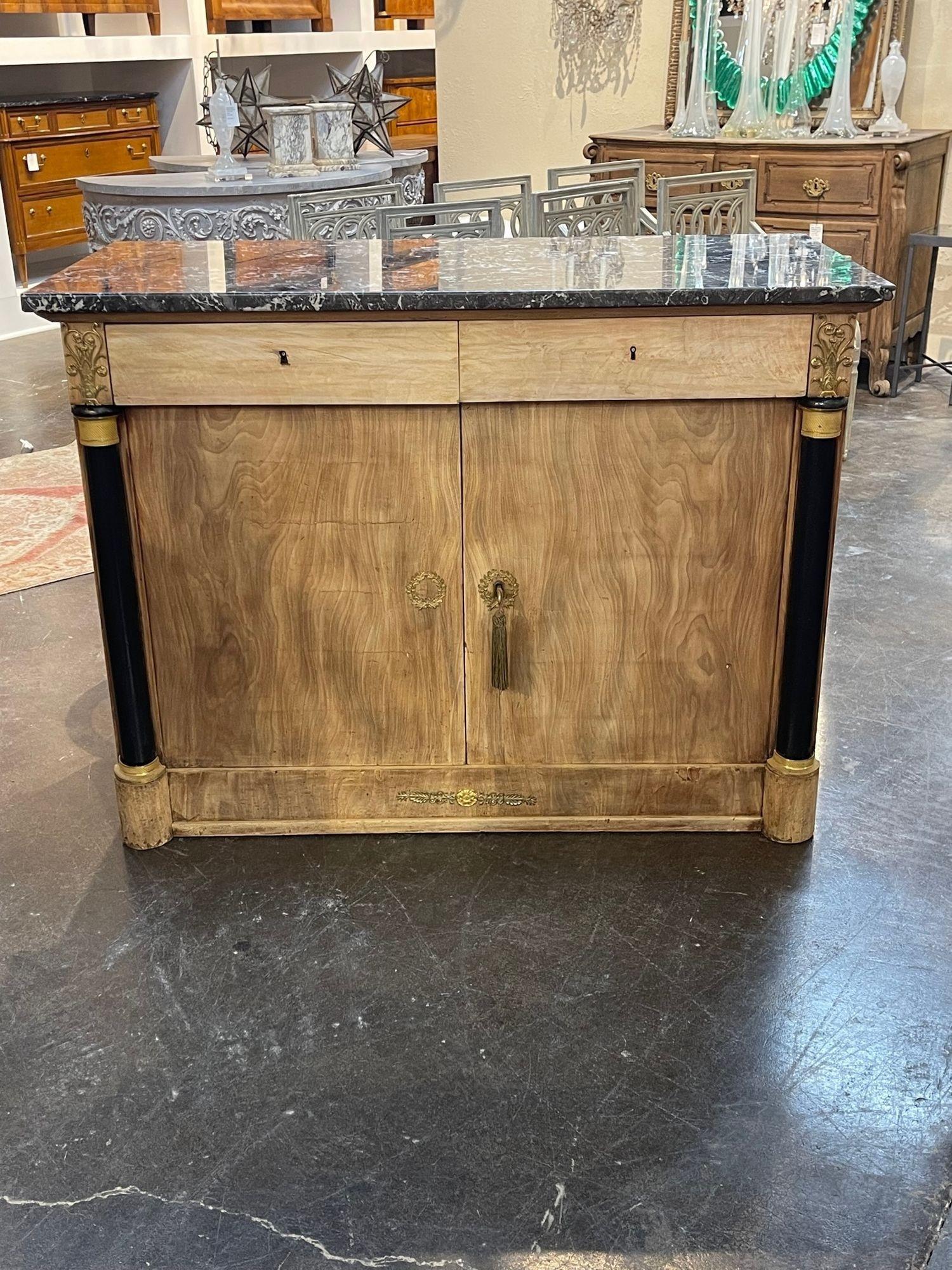 Elegant 19th century Empire style carved and bleached mahogany buffet with grey marble top. This piece has beautiful wood grain and nice storage inside. Lovely!!