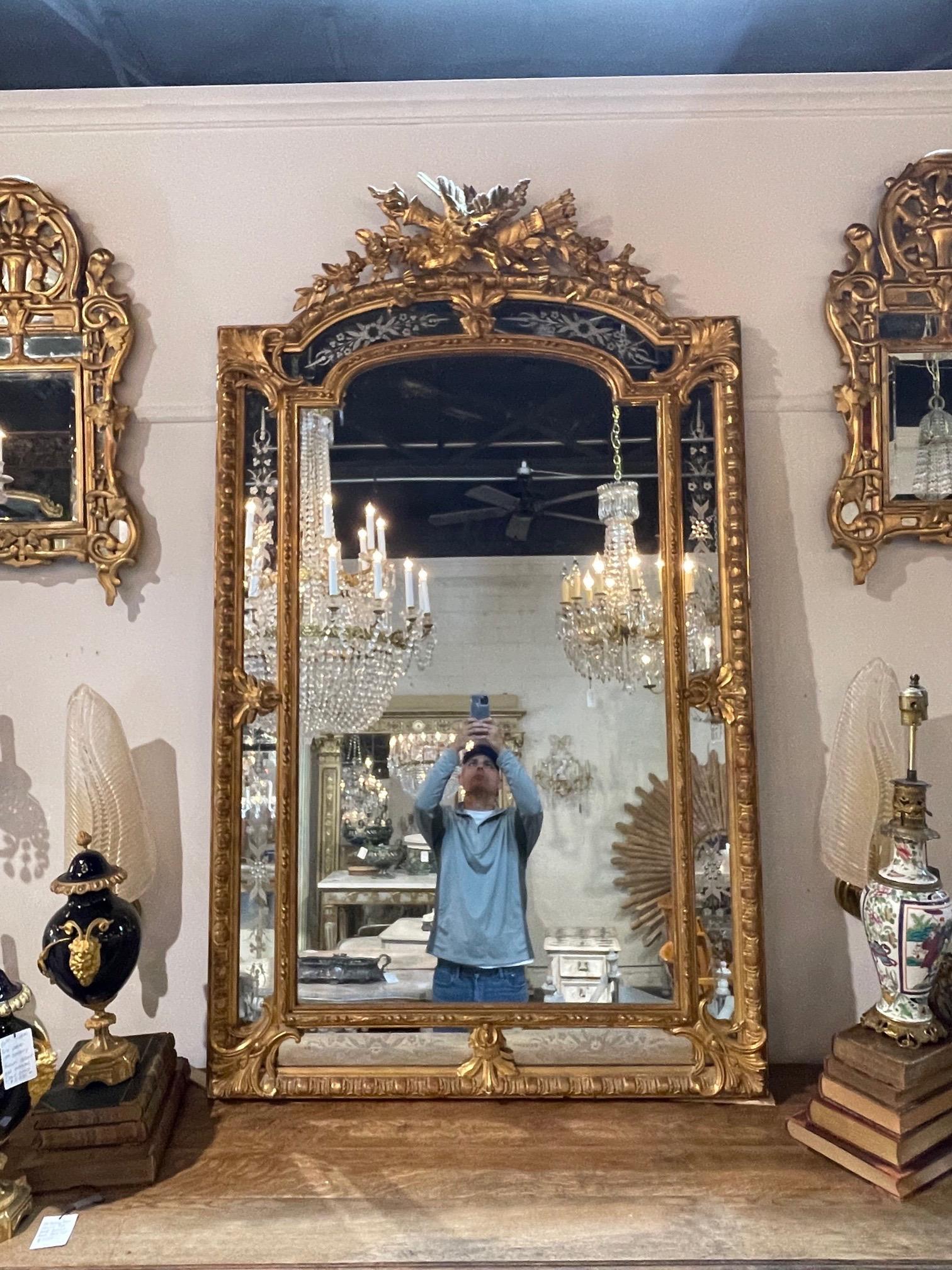 Exquisite 19th century French Louis XVI style carved and giltwood mirror. Beautiful elaborate carvings and very Fine etchings on the outer border make this mirror extra special. Stunning!