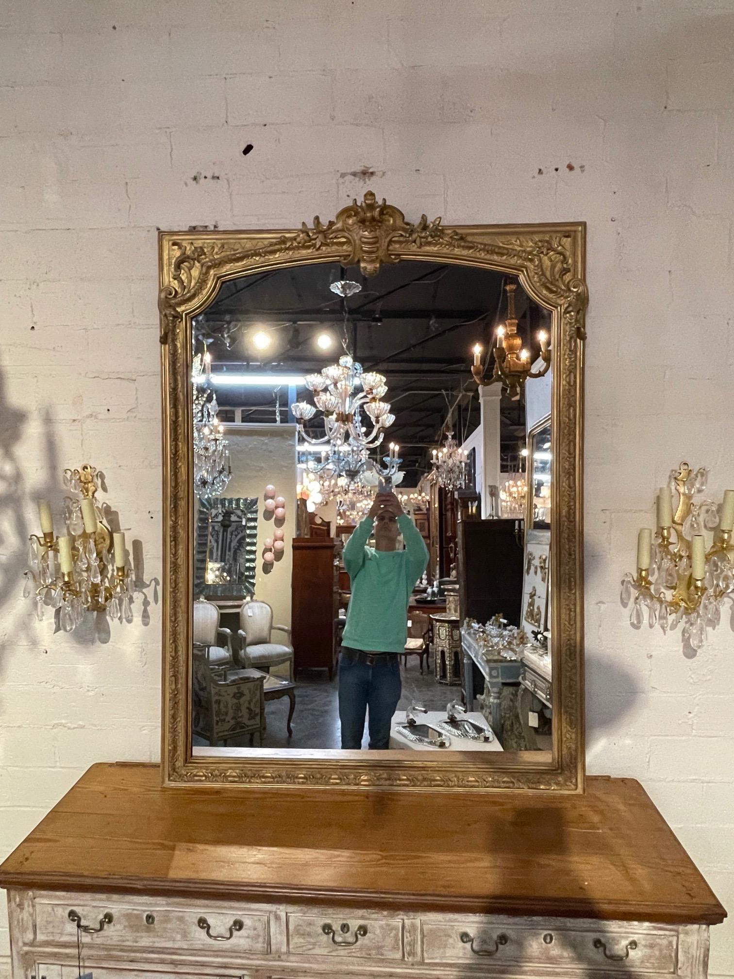Very fine 19th century large French Louis XVI style carved and giltwood mirror. Nice crest and pretty carving on this piece. Adds a real touch of elegance!