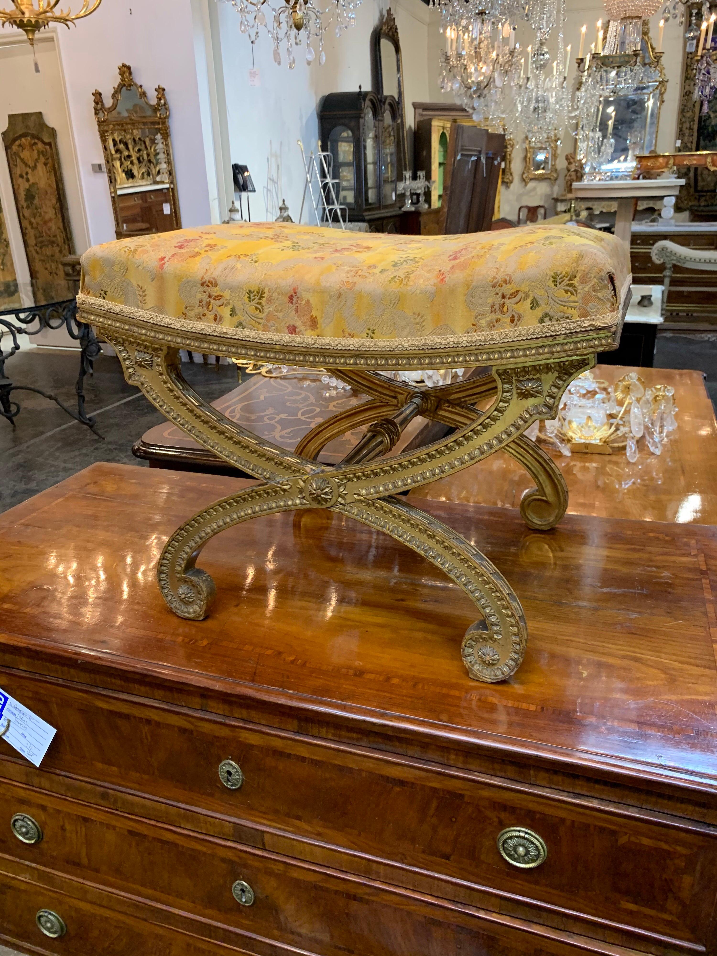 Very decorative 19th century French Louis XVI style carved and giltwood stool. Exceptional carving on this piece along and upholstered in a lovely yellow silk floral fabric. A Classic beauty!
