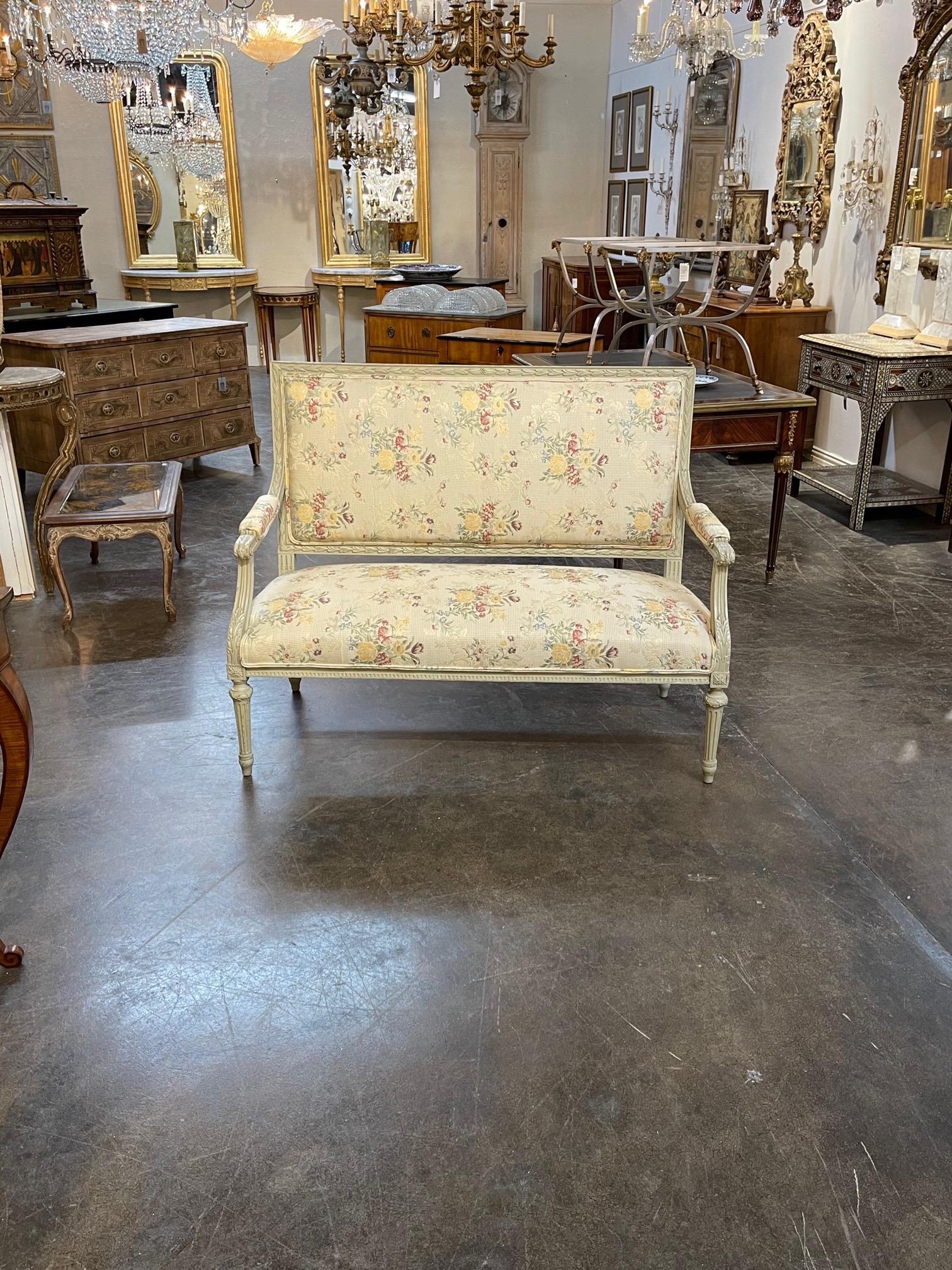 Splendid pair of the 19th century French Louis XVI style carved and painted settees. The pair is upholstered in a beautiful floral pattern. So pretty!! Note: Price listed is per item.